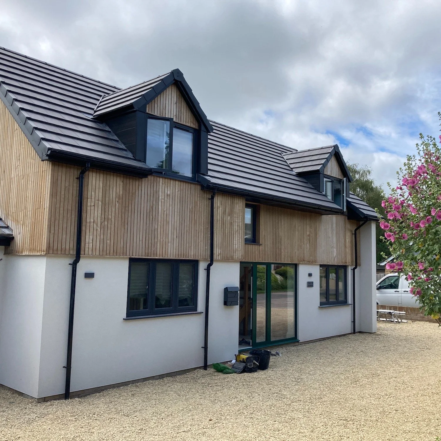 A significantly remodelled home centred around light, openness and simplicity.

The double-height entrance hall, oak staircase and glazed balustrades create a bright and welcoming interior, while timber cladding and crisp rendered elevations give the