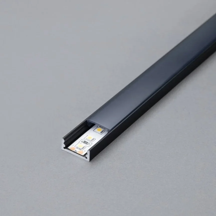 Système d'éclairage LED intégré dans un profilé en aluminium noir pour encastrement.
