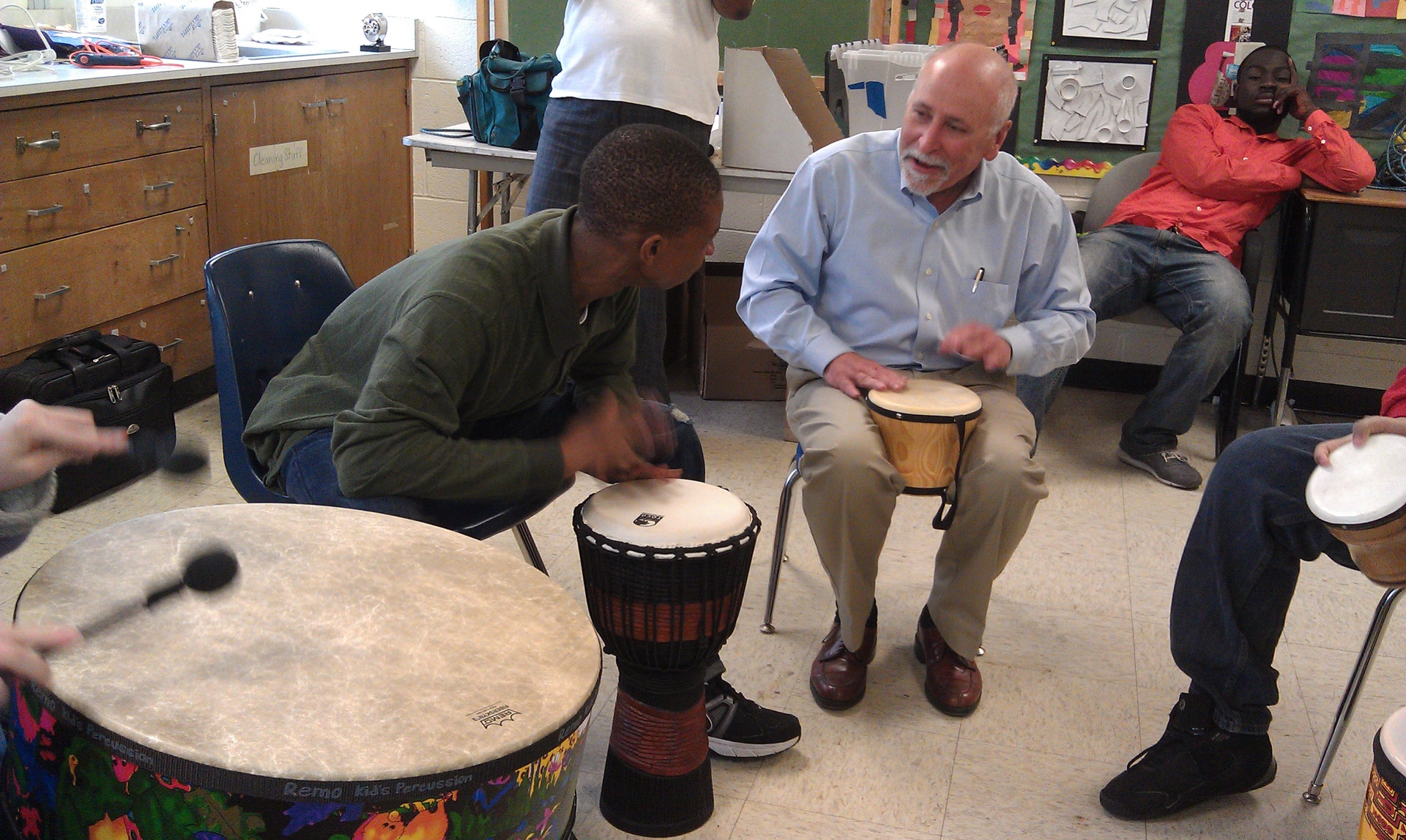 Doctor using drumming to make a connection.