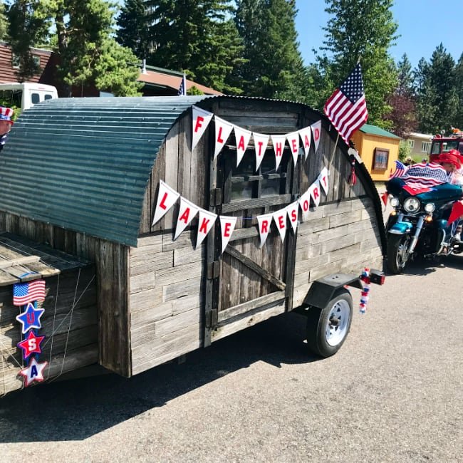 4th of July annual event in Bigfork Montana camper with flags.jpg
