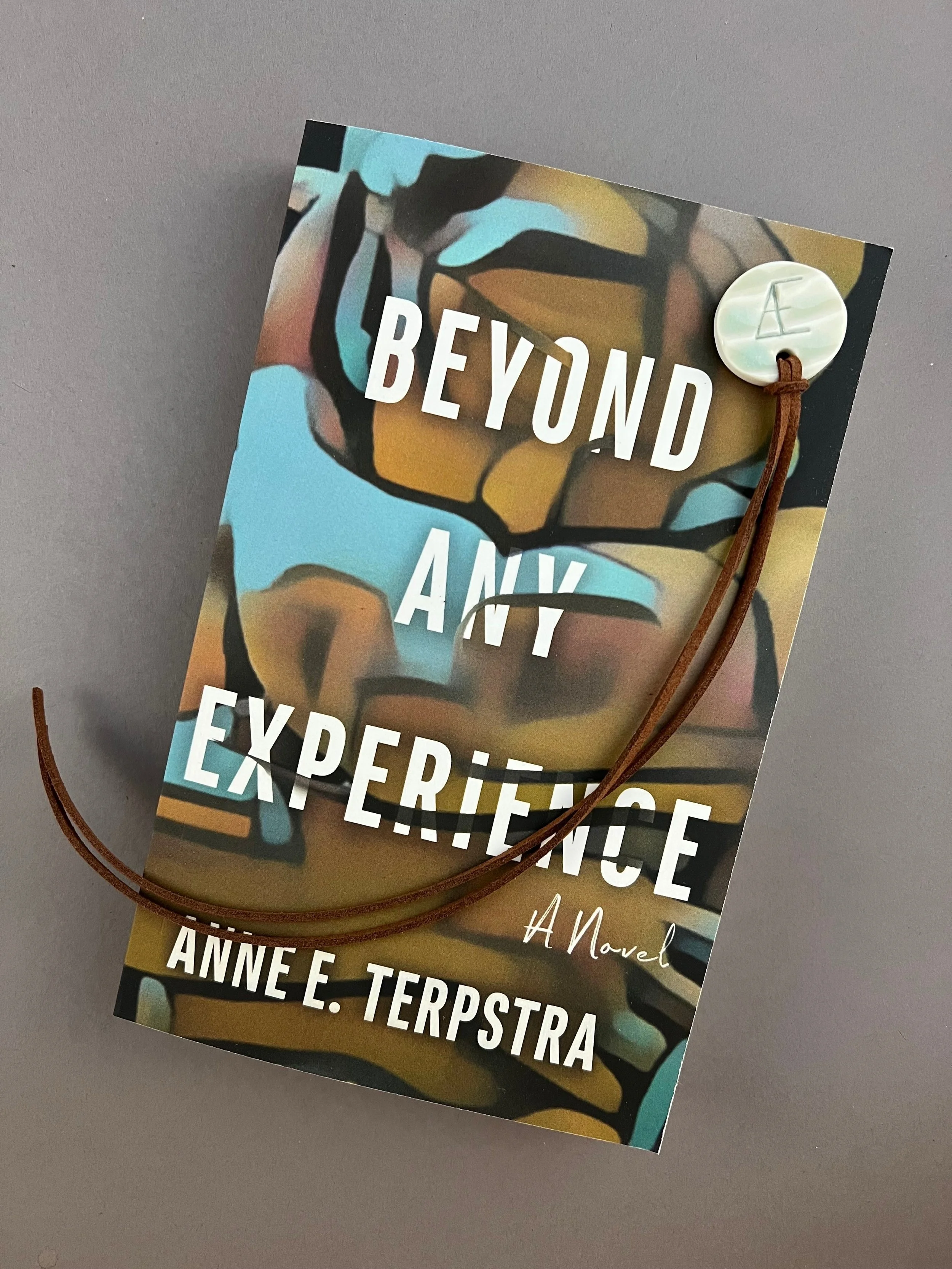 Signed Paperback of Beyond Any Experience + Ceramic Bookmark