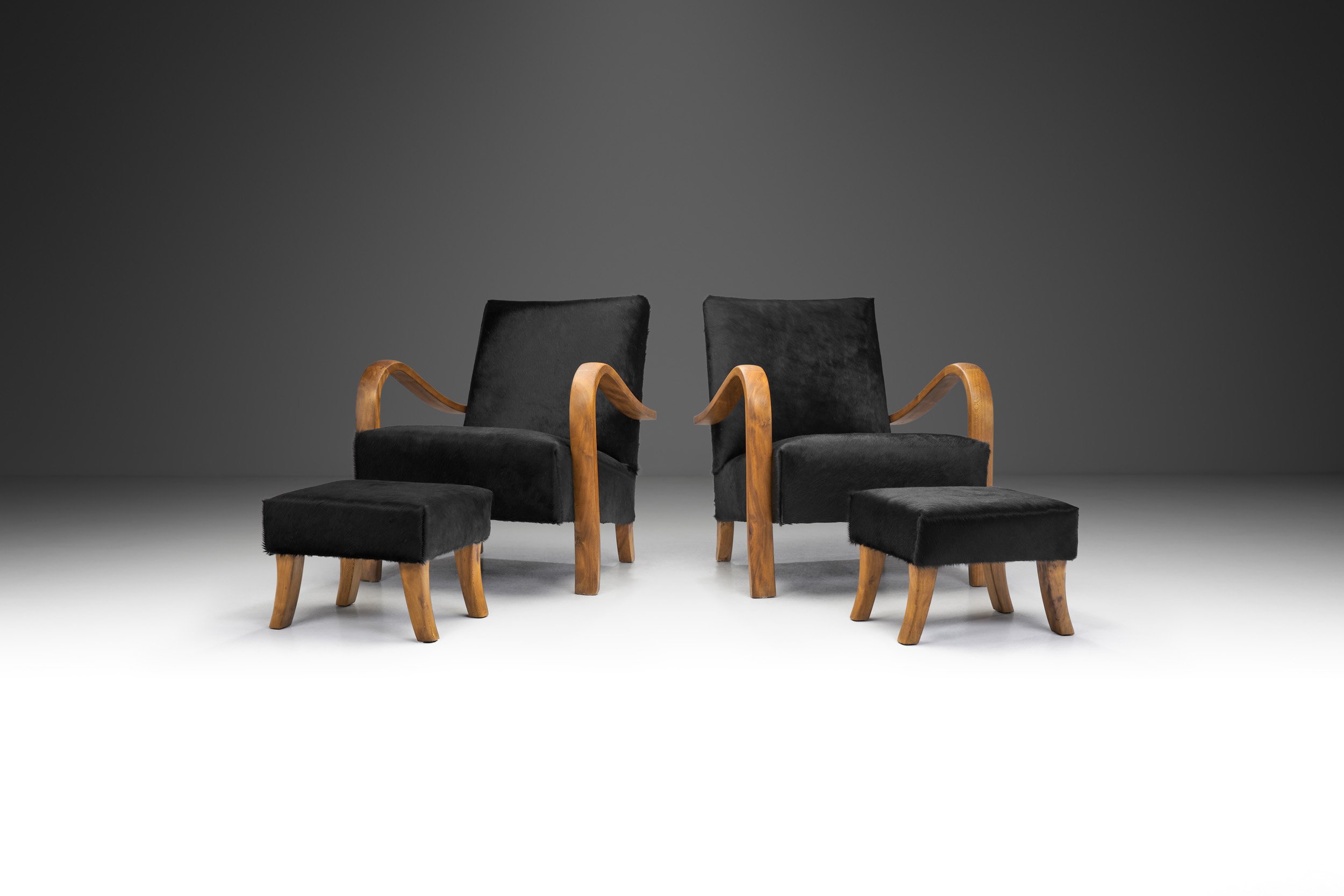 Italian Cherry Wood Lounge Chairs with Foot Stools in Dark Cowhide, Italy 1950s (sold)