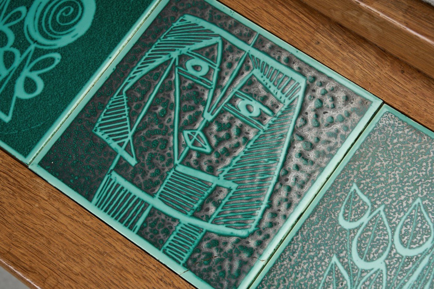 This is one of those rare finds that feels instantly alluring, no matter the setting. Look closer and the details begin to reveal themselves: the unexpected pop of the tiled table works together with the piece's sculptural oak frame and rippled cushi