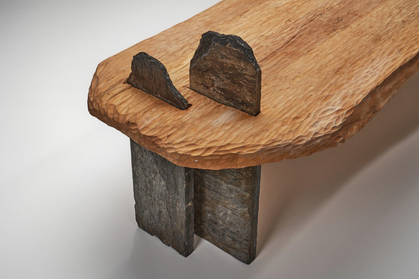 This sculptural coffee table brings together natural materials and bold forms that challenge the boundaries of furniture design. Its interplay of textures and materiality creates a dialogue between the man-made and the organic, where the richly textu