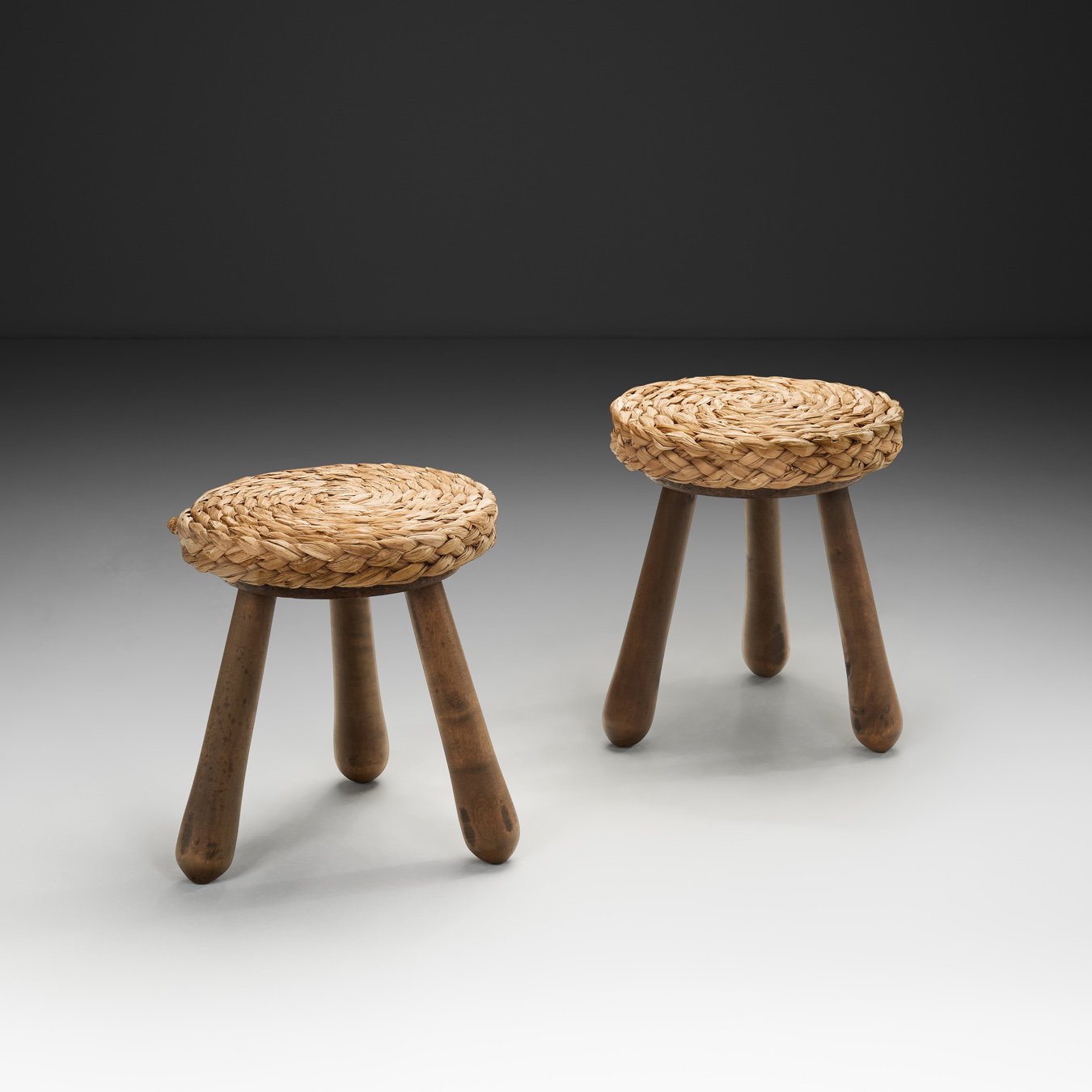 Pair of Wood and Wicker Stools in the manner of Audoux-Minet, Europe Mid-20th Century