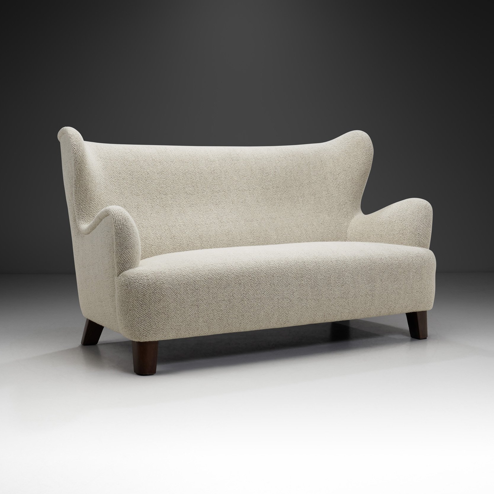 European Upholstered Wingback Sofa with Stained Wood Feet, Europe 20th century