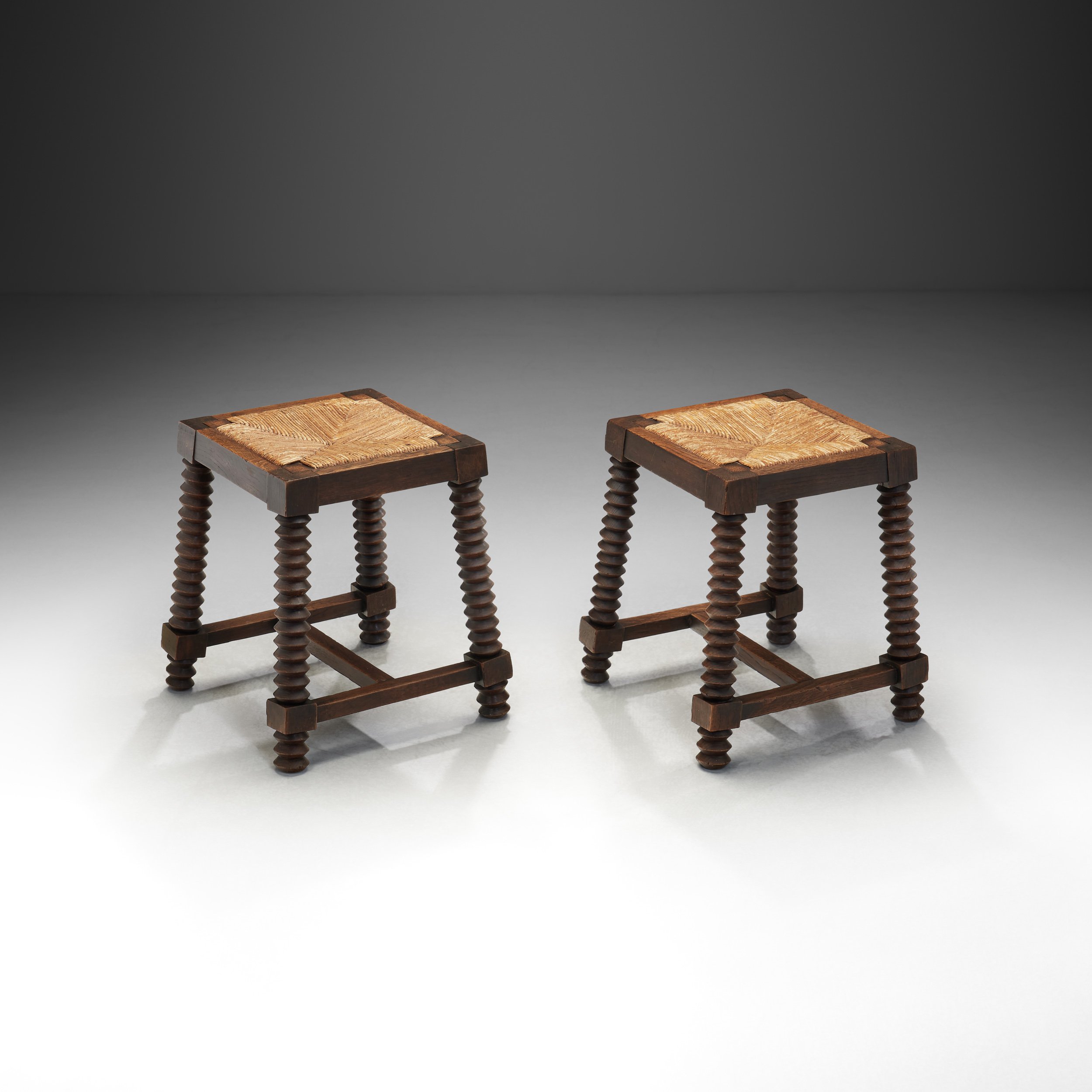 Pair of Oak and Woven Rush Stools in the manner of Charles Dudouyt, France 20th Century (sold)
