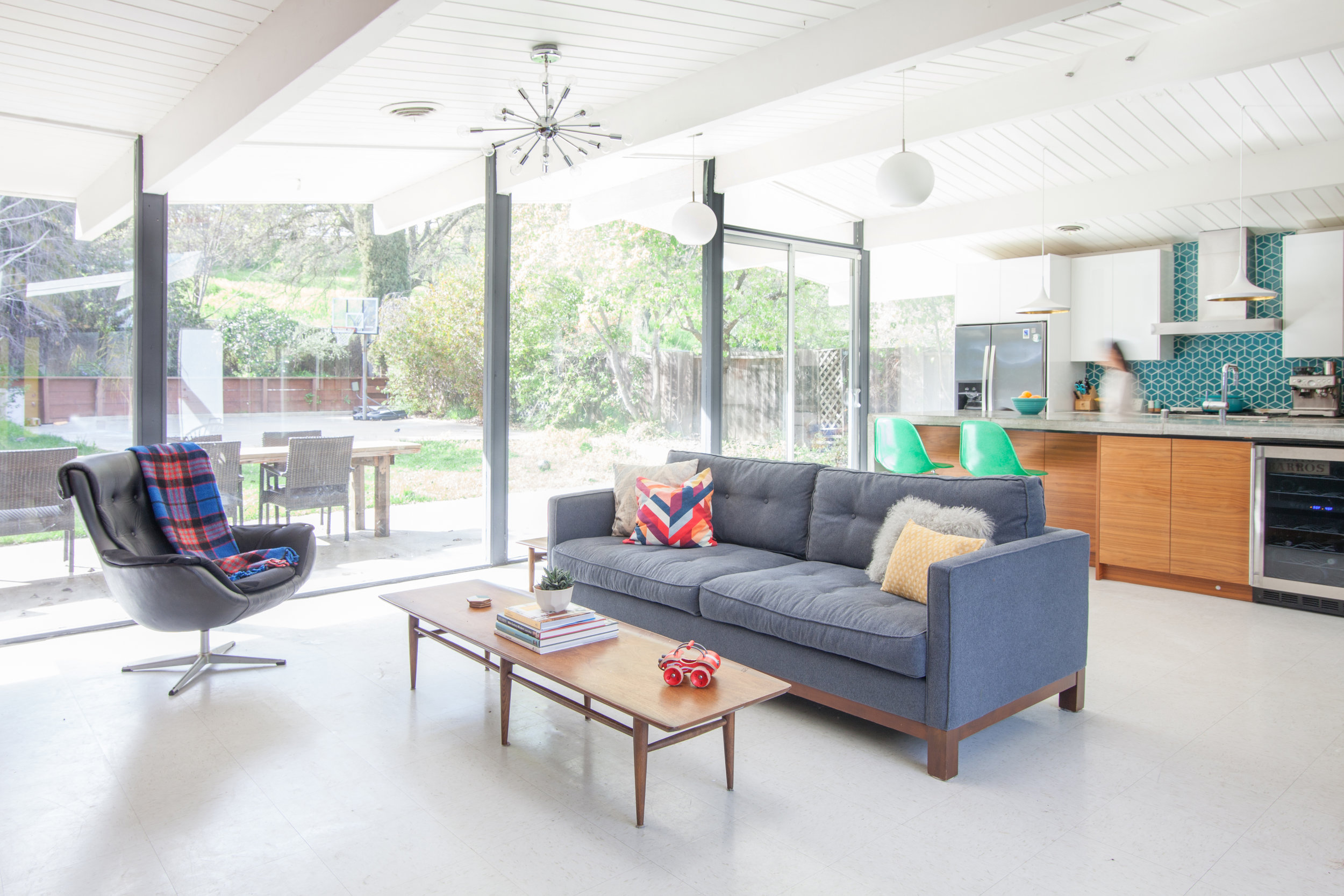 Updates to this home restoration and renovation feature pre-casted concrete counters, walnut cabinetry and designer lighting to balance original architecture with modern design.