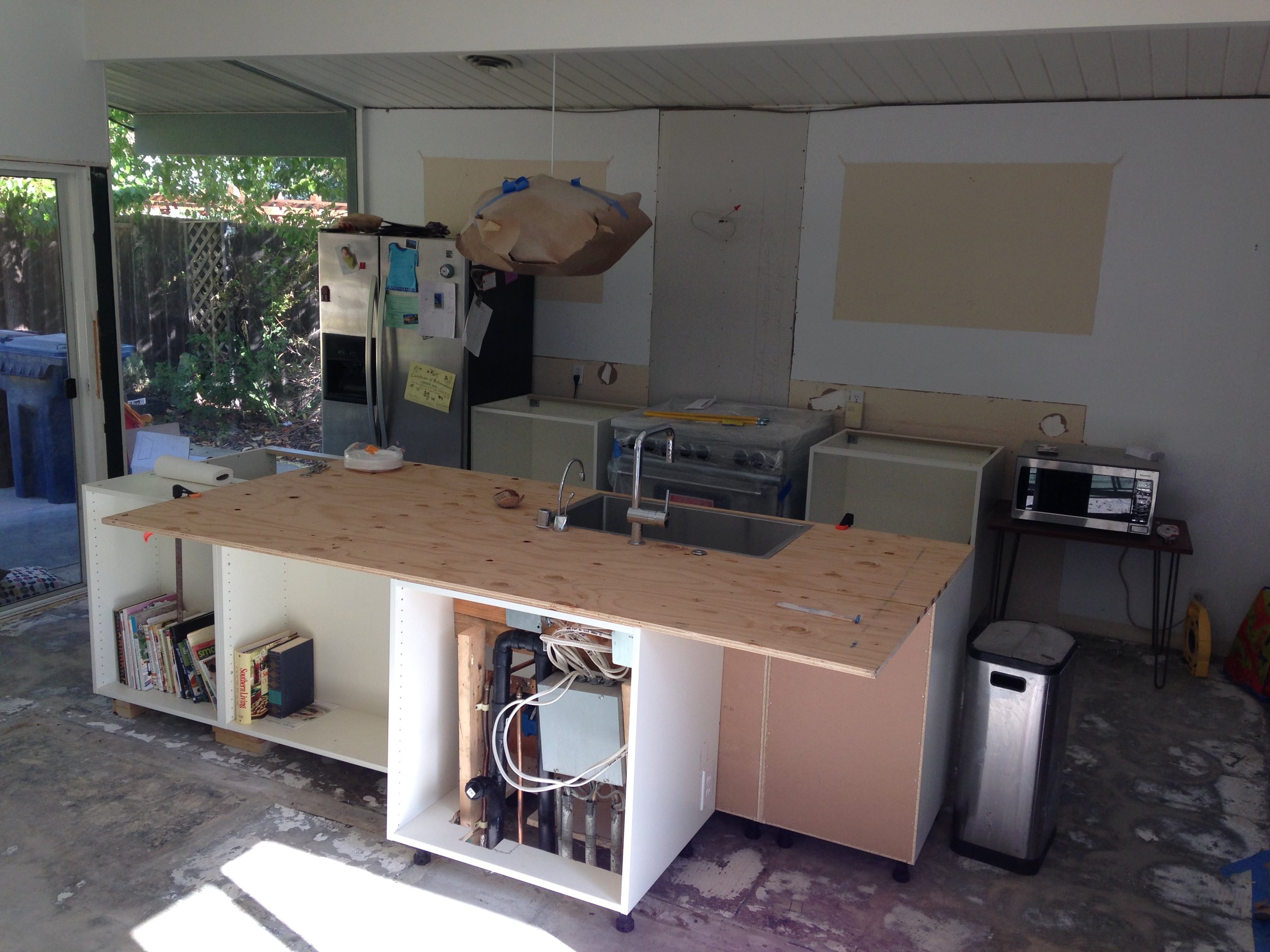 Cabinet boxes in place - plywood surface mounted - enough to get a kitchen sink back into play.