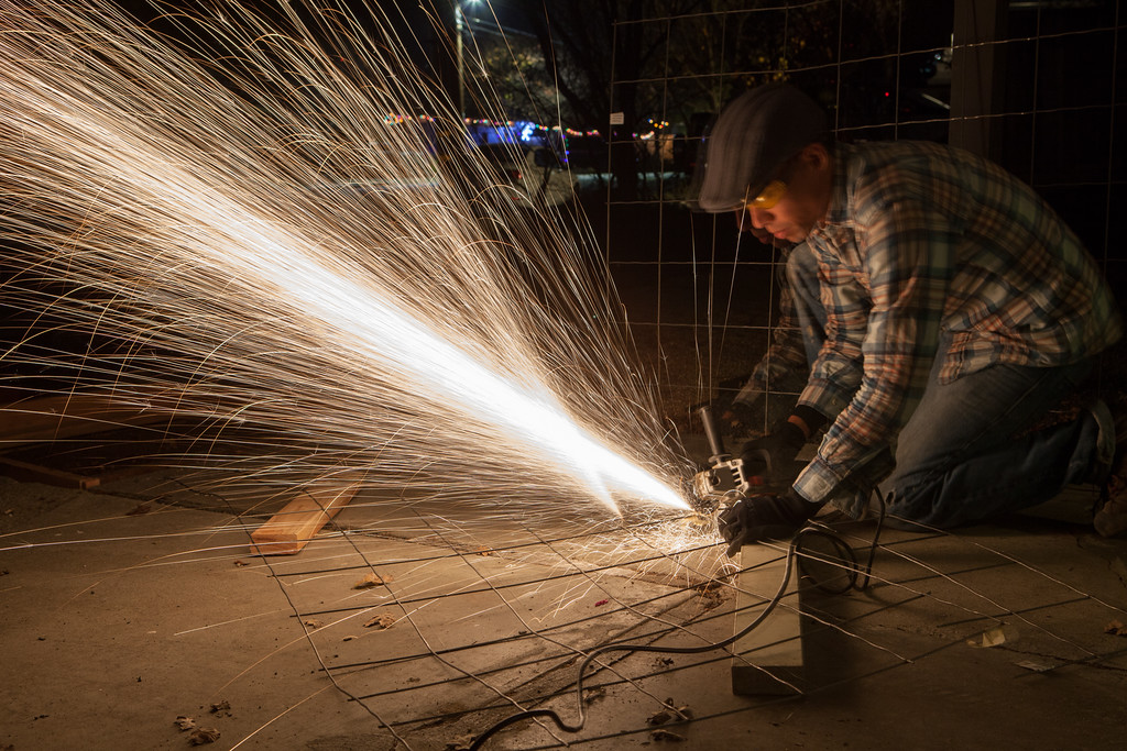 Cutting mesh at night with an angle grinder.