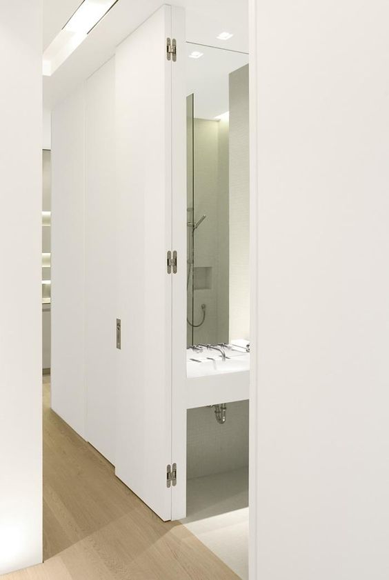 This door allows for 180 degree action, which in this case was required to offer the hall bathroom an outswing, while folding out of the way for someone passing by. 