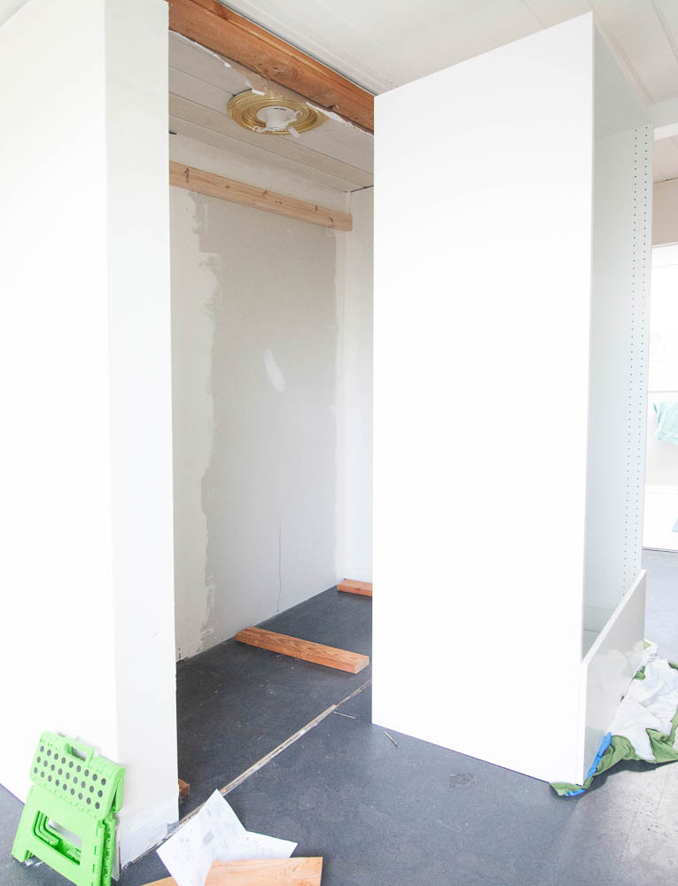 Installed our twin 2x4 ledger into studs so the cabinet frames could anchor anywhere along the horizontal plane. Placed 2x4s on the floor instead of using the supplied plastic feet that were an inch too high.