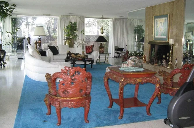 Beautiful terrazzo tile floors in the main Living Room. Most of the original brick walls were covered in mirrors. (Note the mirrors flanking the Fireplace and lots more mirror around the house.)