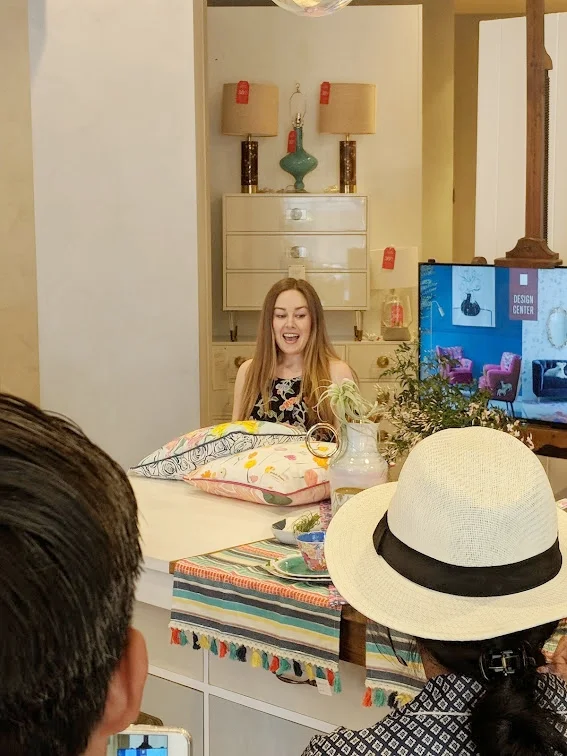The very talented and sweet Bridgette, showing her designs featured on tabletop and pillow collections.