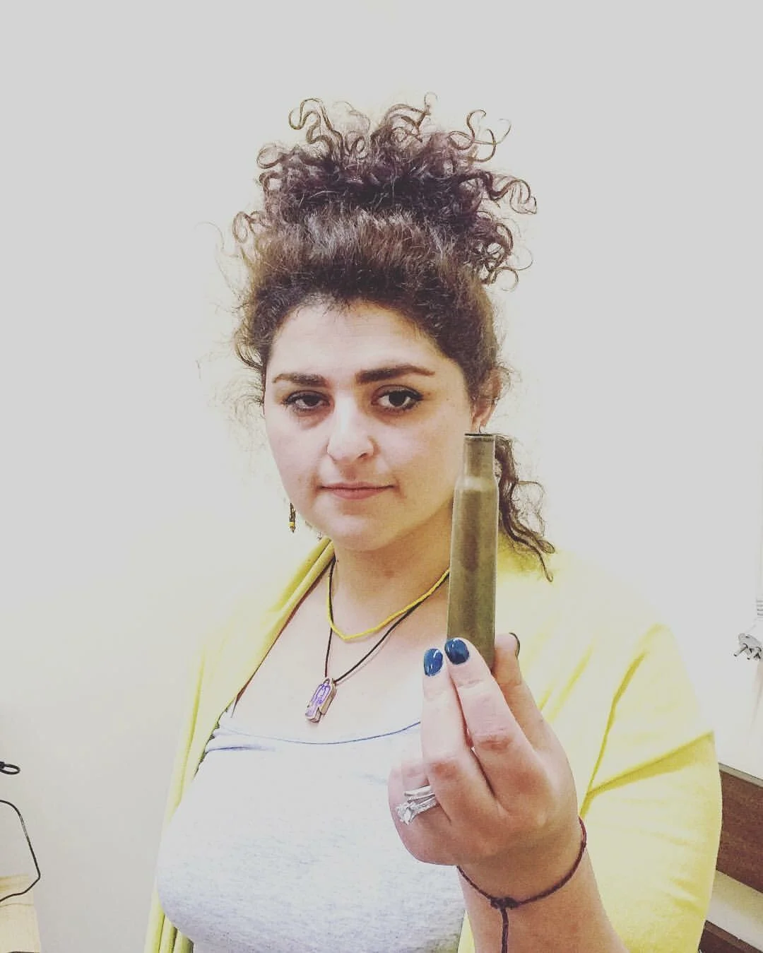 Helena holding one of the bullets collected from Aygepar