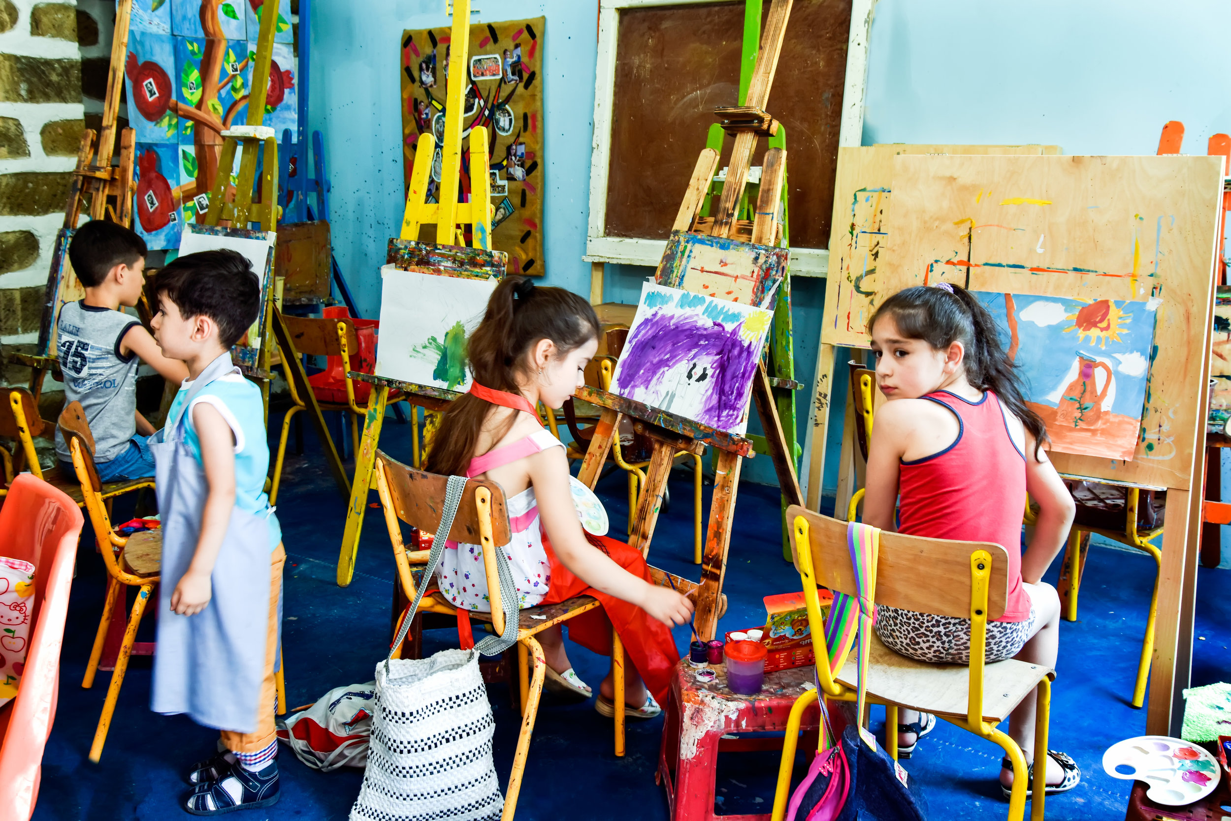 Young painters at work in the studio.