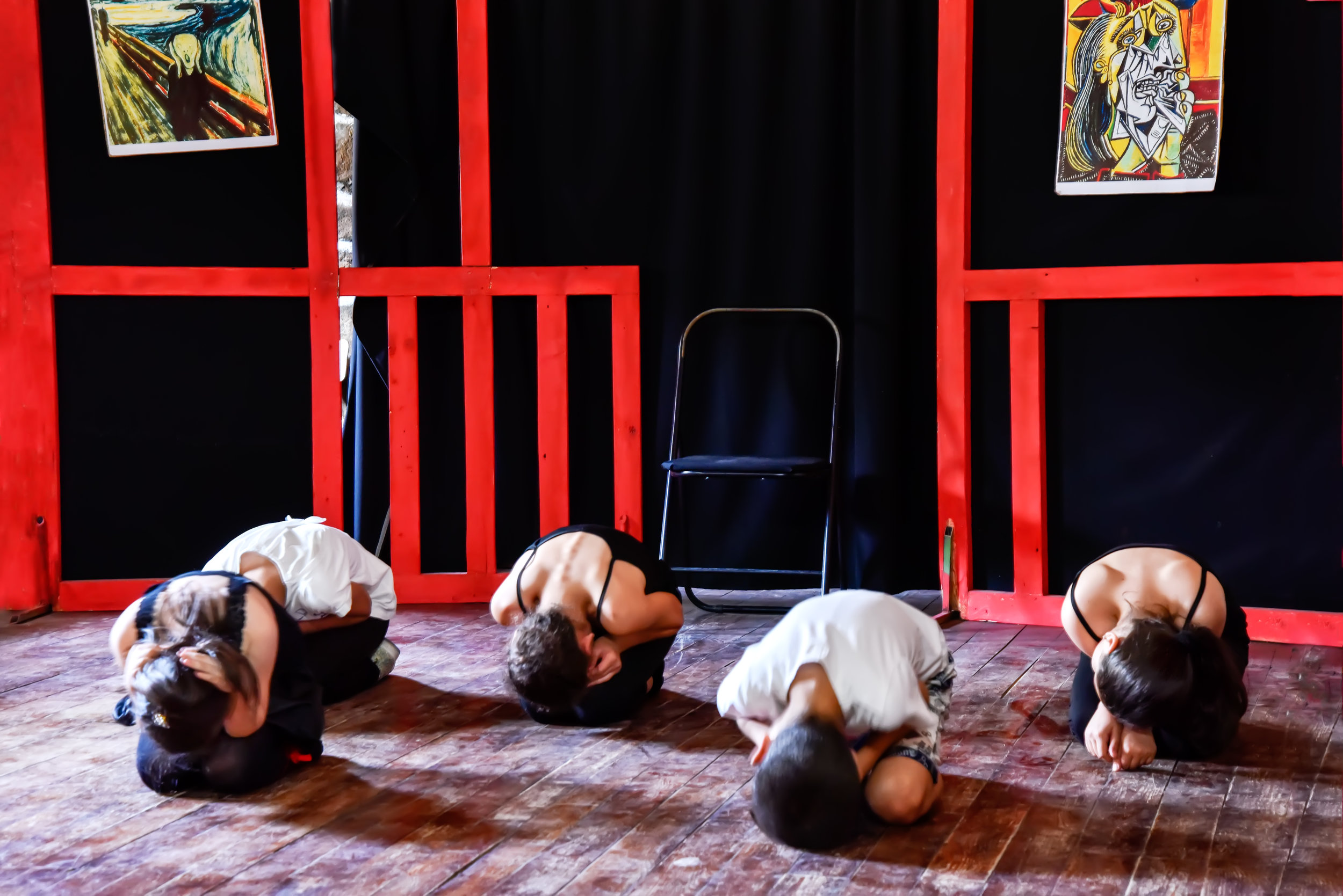Kids in motion at a drama class in the small existing theater.