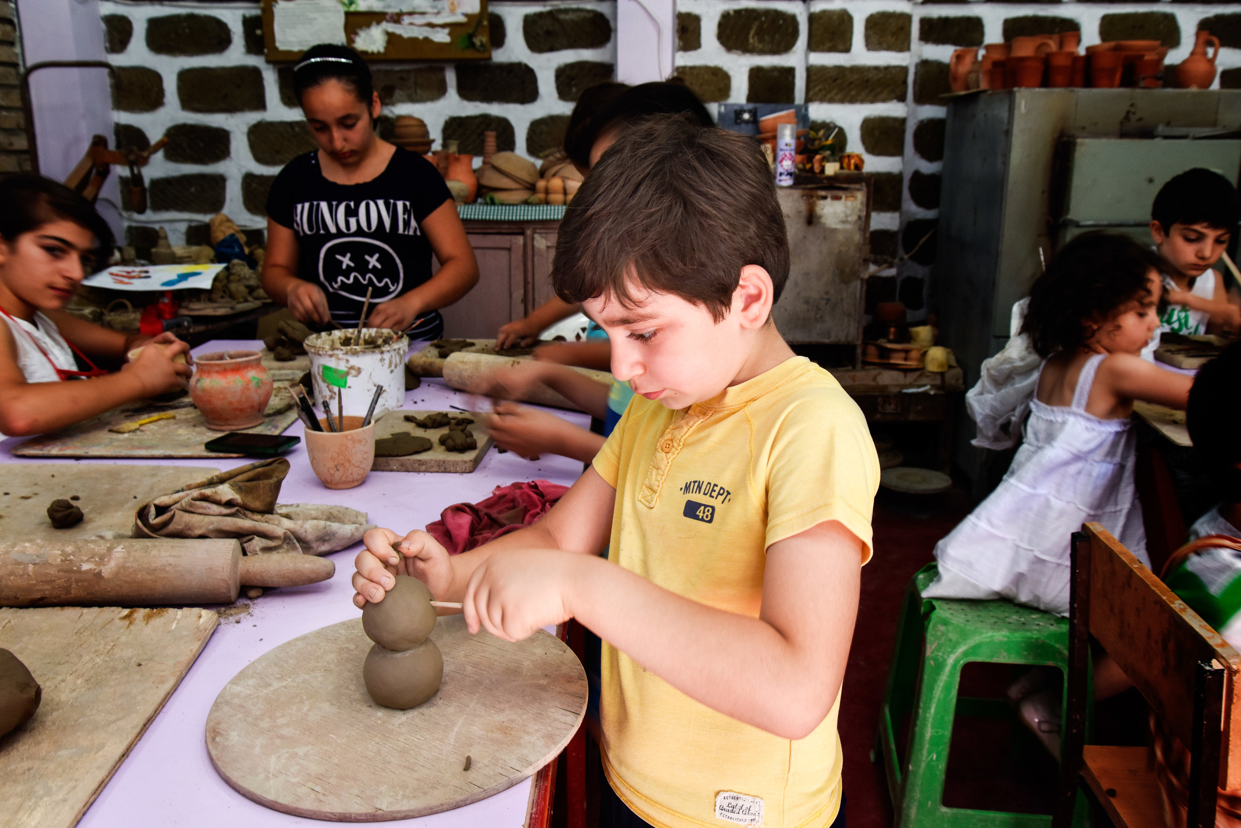 Pottery classes, where young artists make figures like the ones above.
