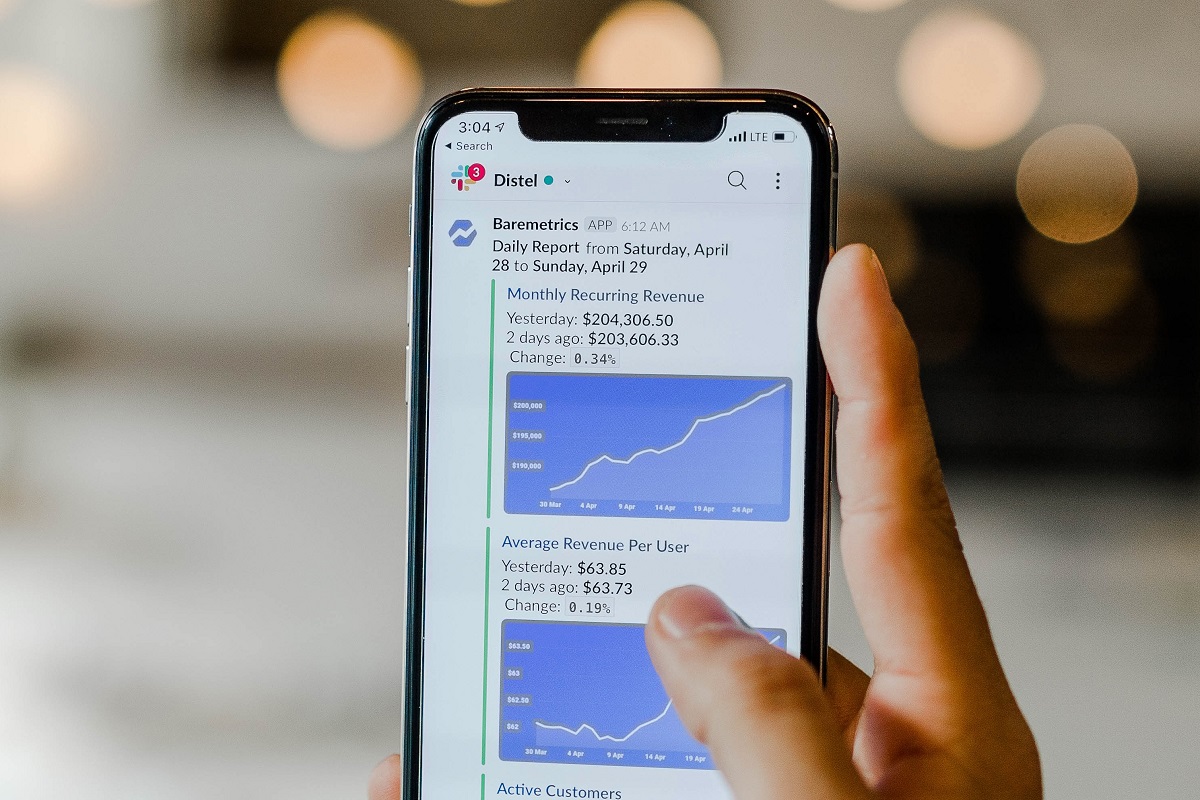 A mobile phone is shown with the messaging app Slack on the screen. Photo by Austin Distel on Unsplash