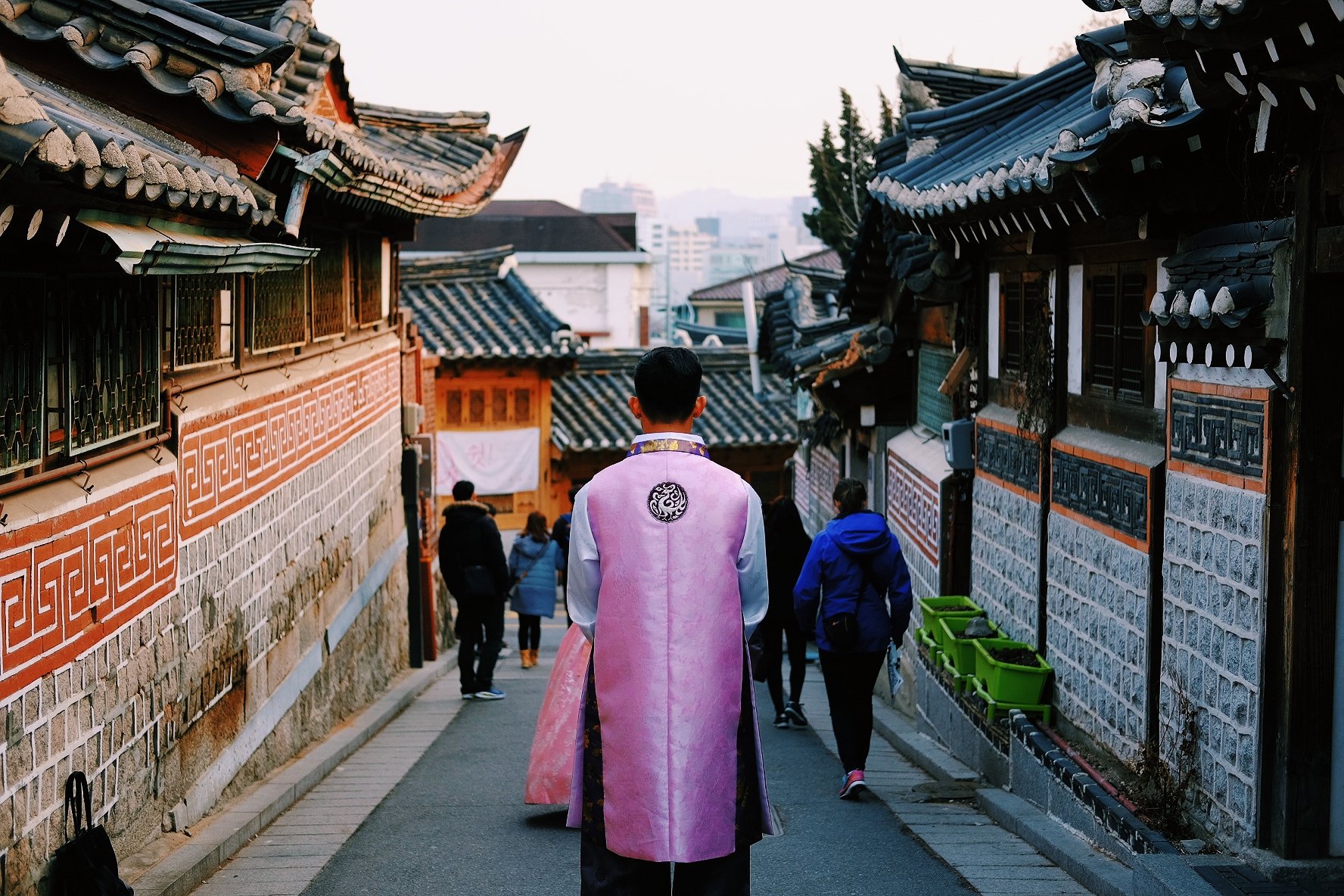  Man dressed in traditional Korean hanbok in Bukchon Hanok Village in Seoul, South Korea 
