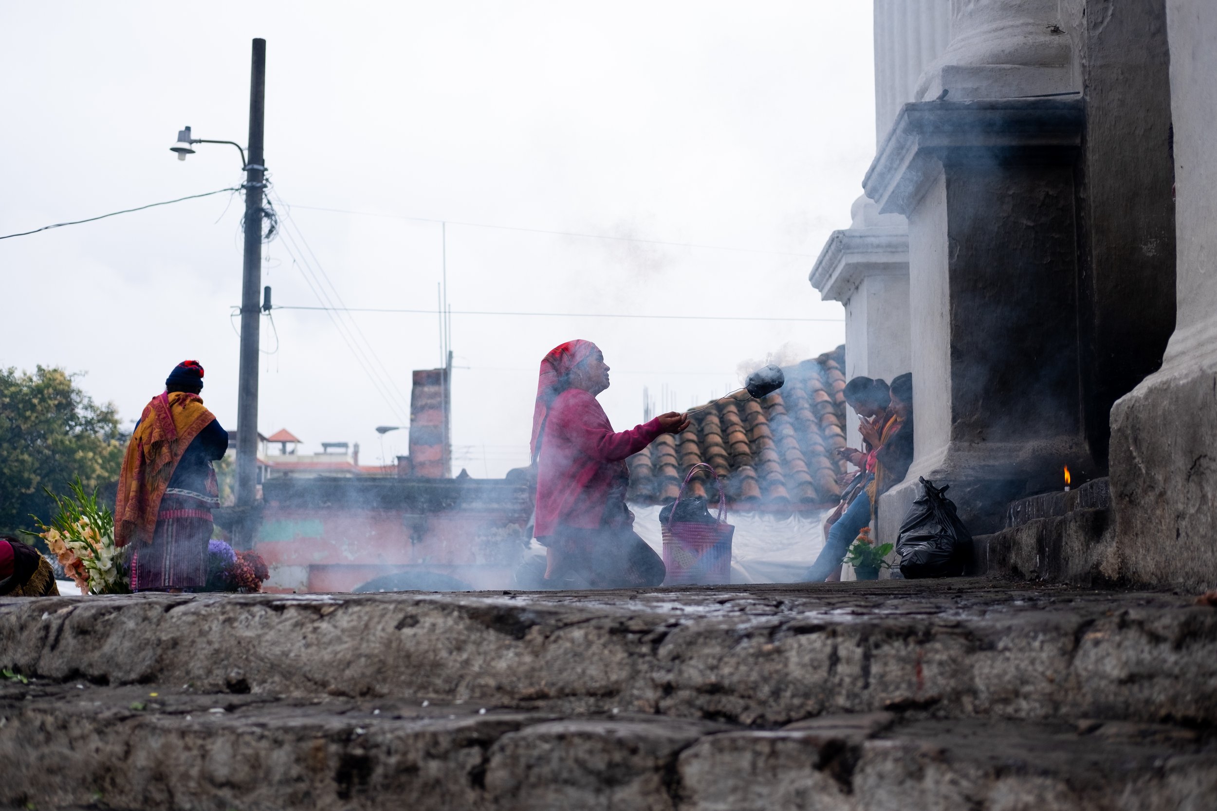  Woman kneeling in front of a church in Chichicastenango, Guatemala 