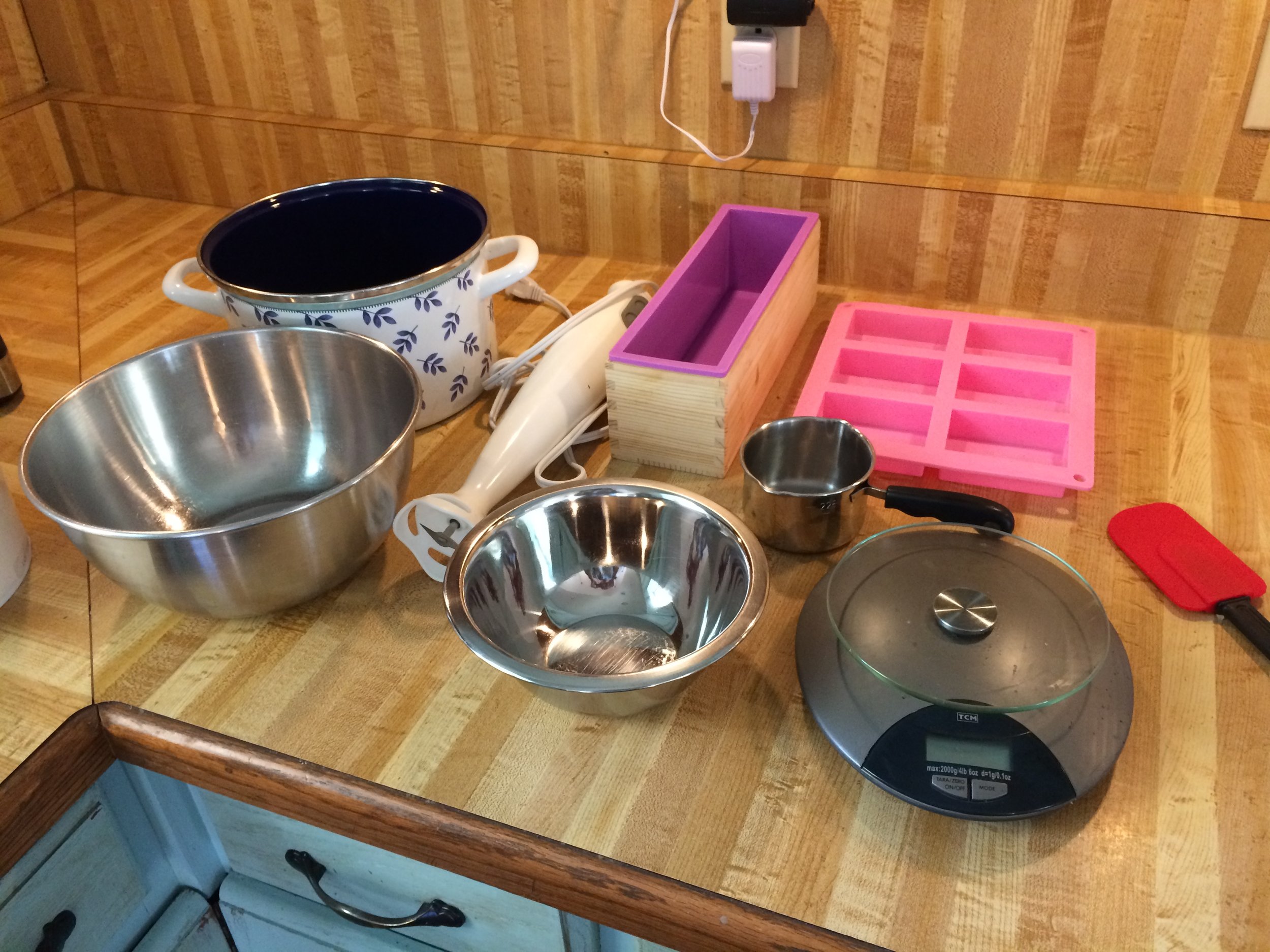 you will need a metal pot, a heat-resistant bowl (metal or glass), a digital scale, a small bowl for measuring lye, an immersion blender, soap molds, a spoon, and a spatula. For safety purposes, you need rubber gloves, long sleeves, a mask, and eye protection. 