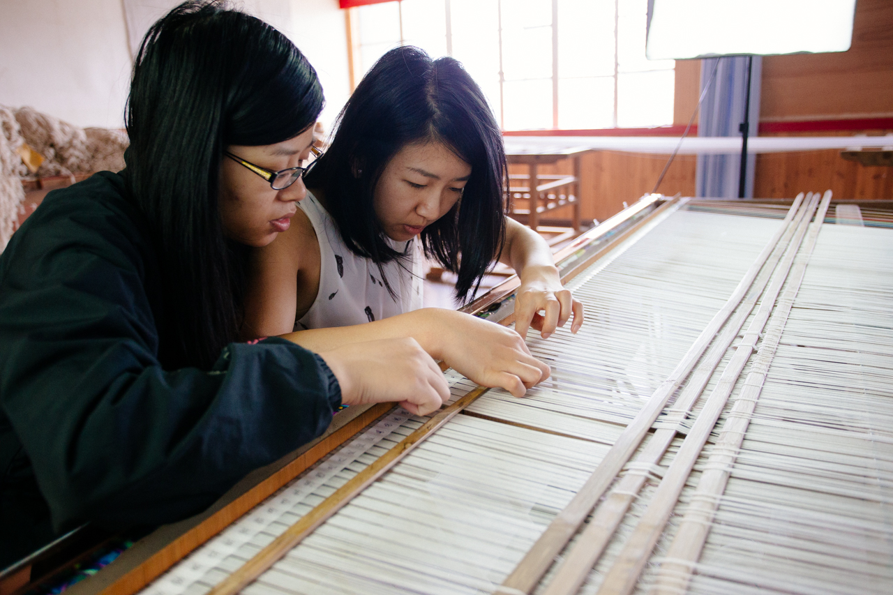 Learning the jacquard weave. The white ropes represent the warp threads, once attached to the loom, the ropes will pull up the threads allowing the weft threads to be woven, thus forming the colours and shapes. 