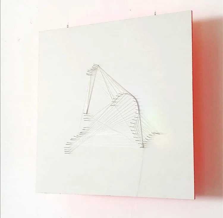 TENSION FIELD &mdash; Acrylic, nails, and thread on wood panel

Threads stretch between nails like frozen movements in space. The construction appears fragile and precise at the same time&mdash;a diagram of tension and relationship. The back, painted