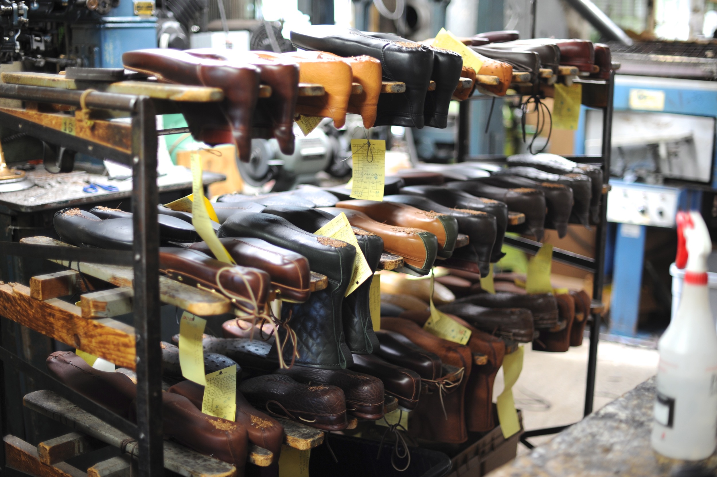 rack of leather shoes with yellow tags