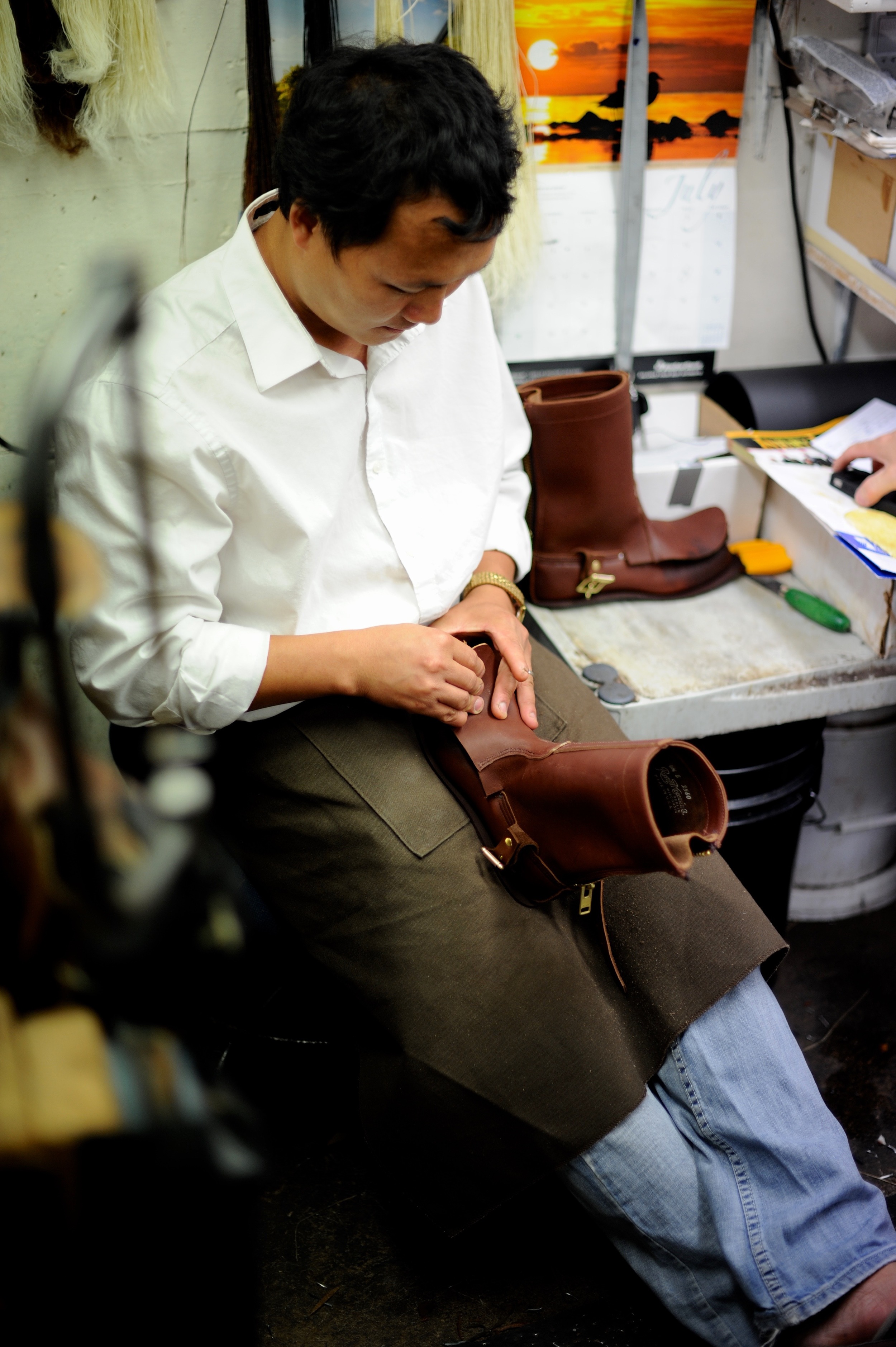 worker crafts a leather boot