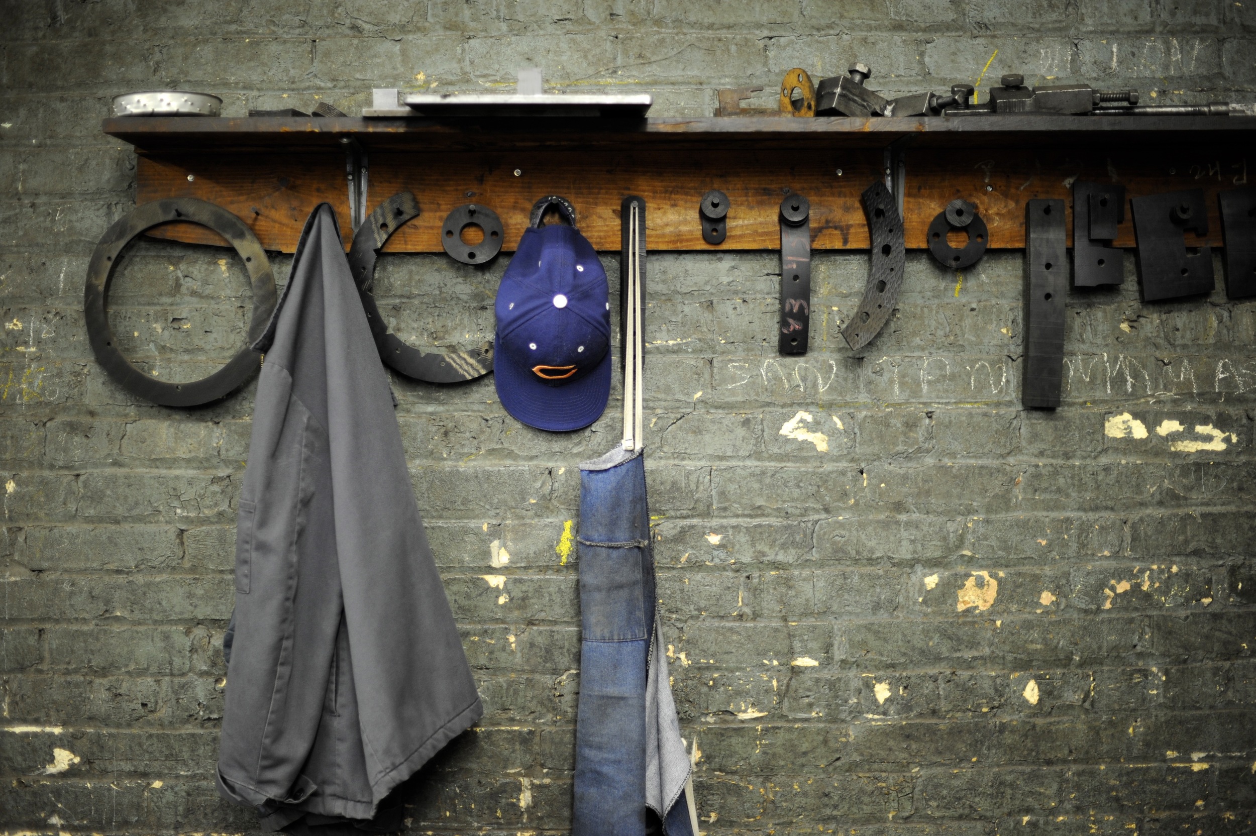 apron and hat hanging on wall