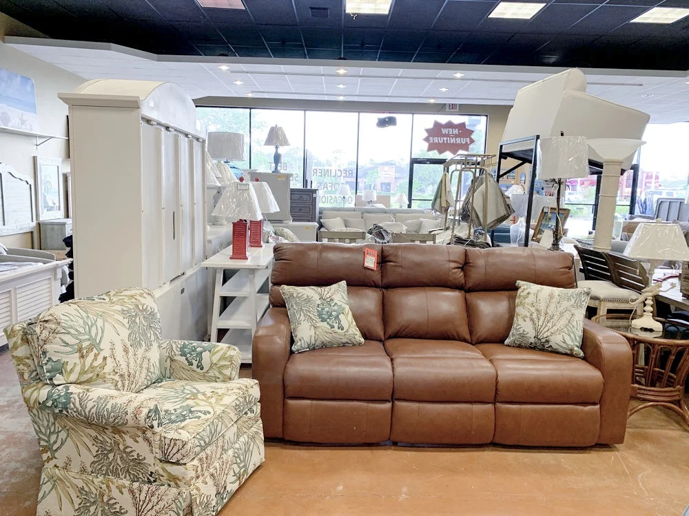 100% LEATHER RECLINING SOFA PAIRED WITH CORAL REEF CARIBBEAN ACCENT PILLOWS + QUINN SWIVEL ARM CHAIR