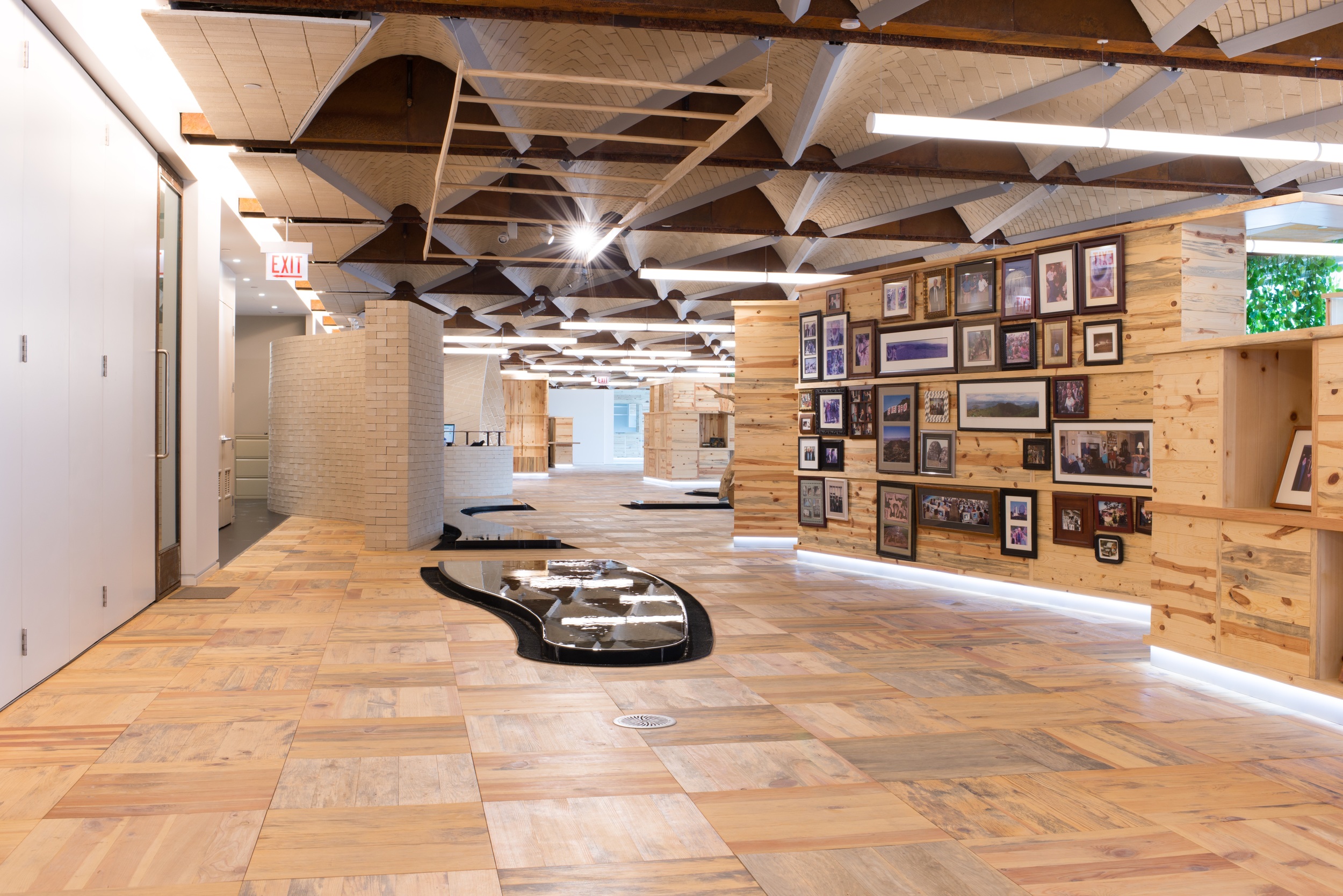 “Vaults” of bricks created from earth from the client’s farm create a dynamic ceiling and ultra-contemporary fixtures and finishes, alongside the living green trellis at the windows.