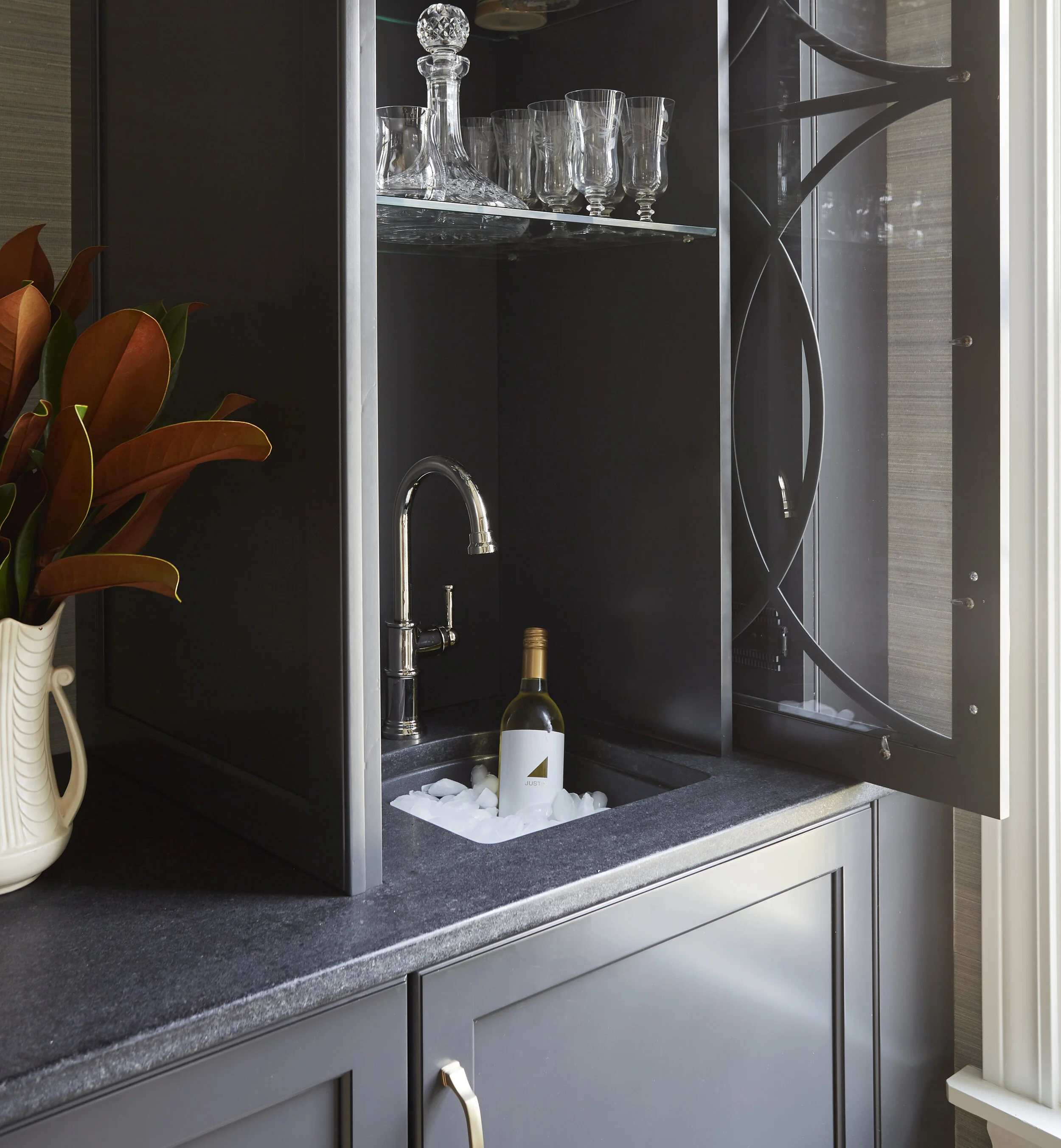 Elegant dining room with a custom built-in buffet that opens to a wet bar when needed. Design by Two Hands Interiors.