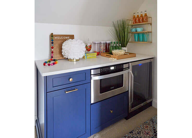 A teen hangout destination with a comfortable boho vibe - with custom snack station. This custom dry bar in a custom blue is completed with Top Knobs hardware and retail accessories.