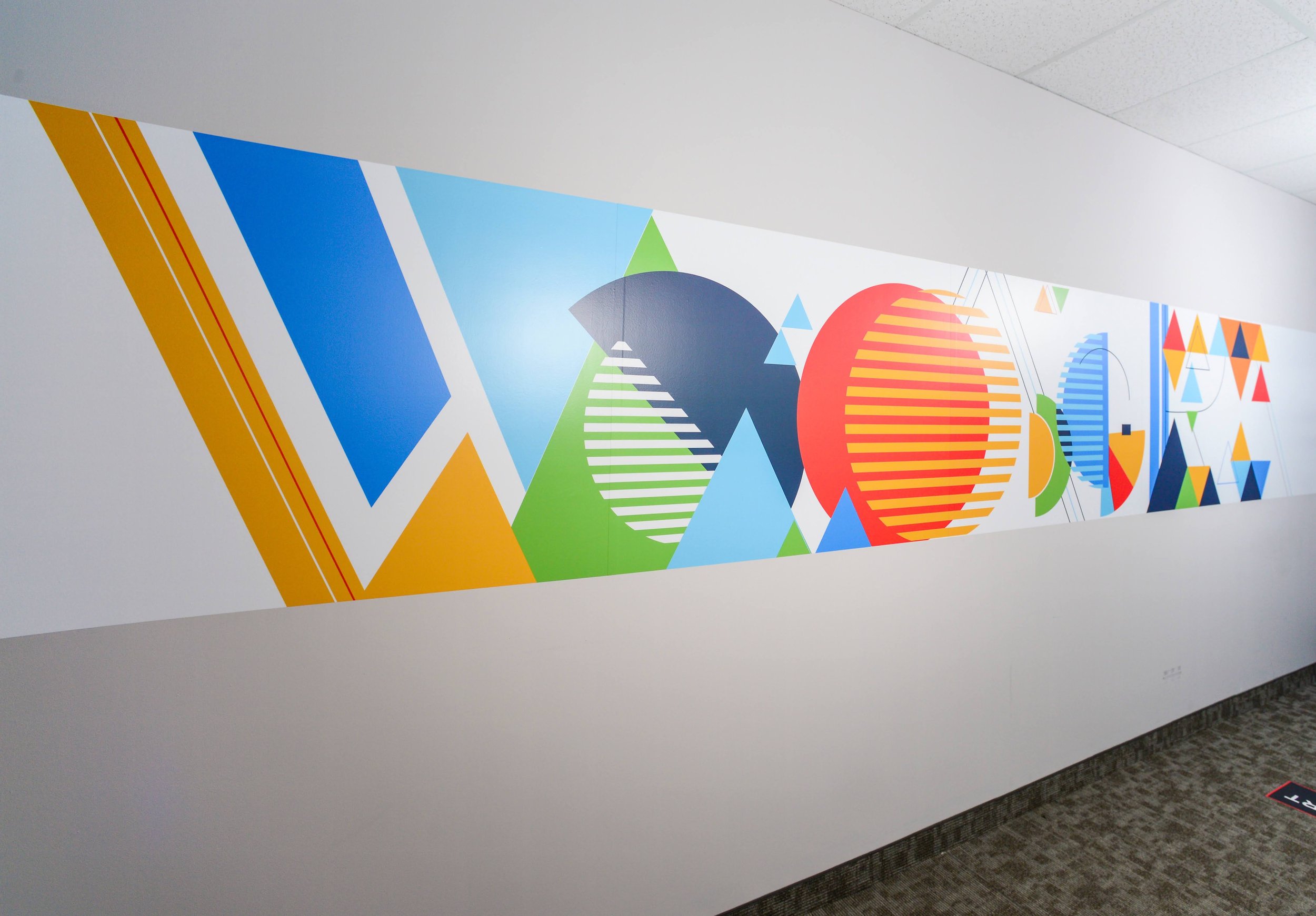 Vibrant geometric environmental graphics for WoodGreen Community Services head office in Toronto by IS Design Labs.