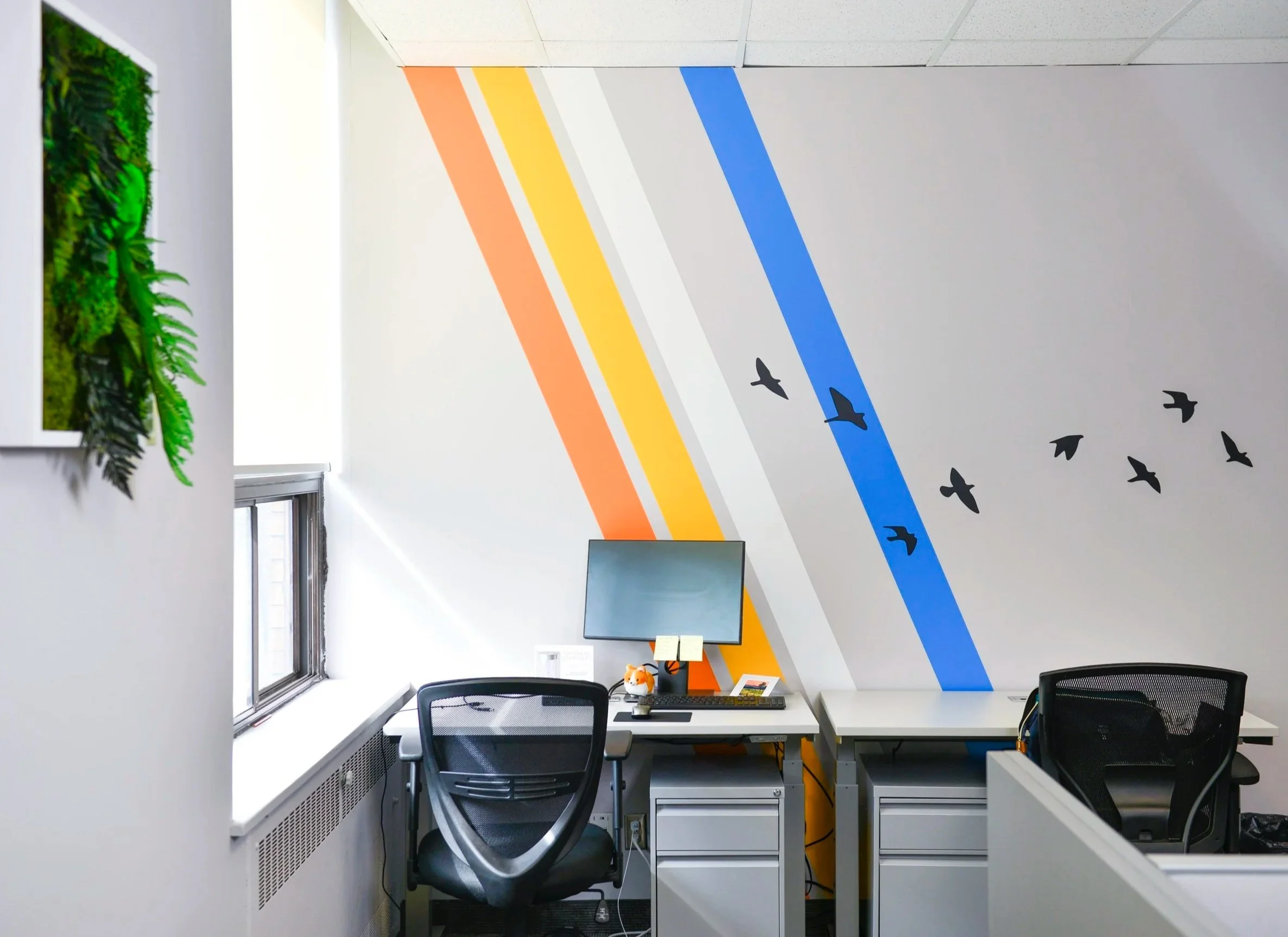 Transforming a workspace through geometric environmental graphics, using bold lines and silhouettes to bring movement and inspiration to an office setting.