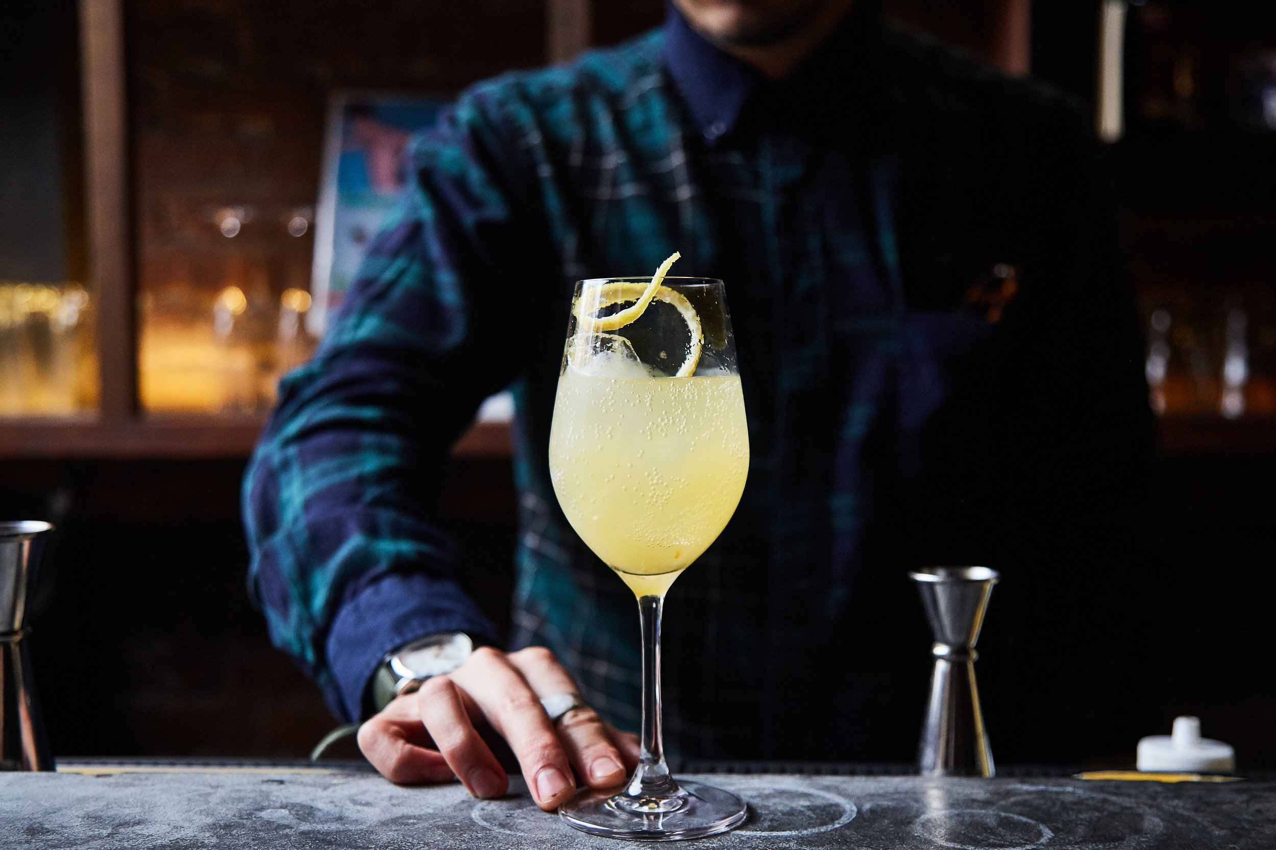  bartender presenting a cocktail 