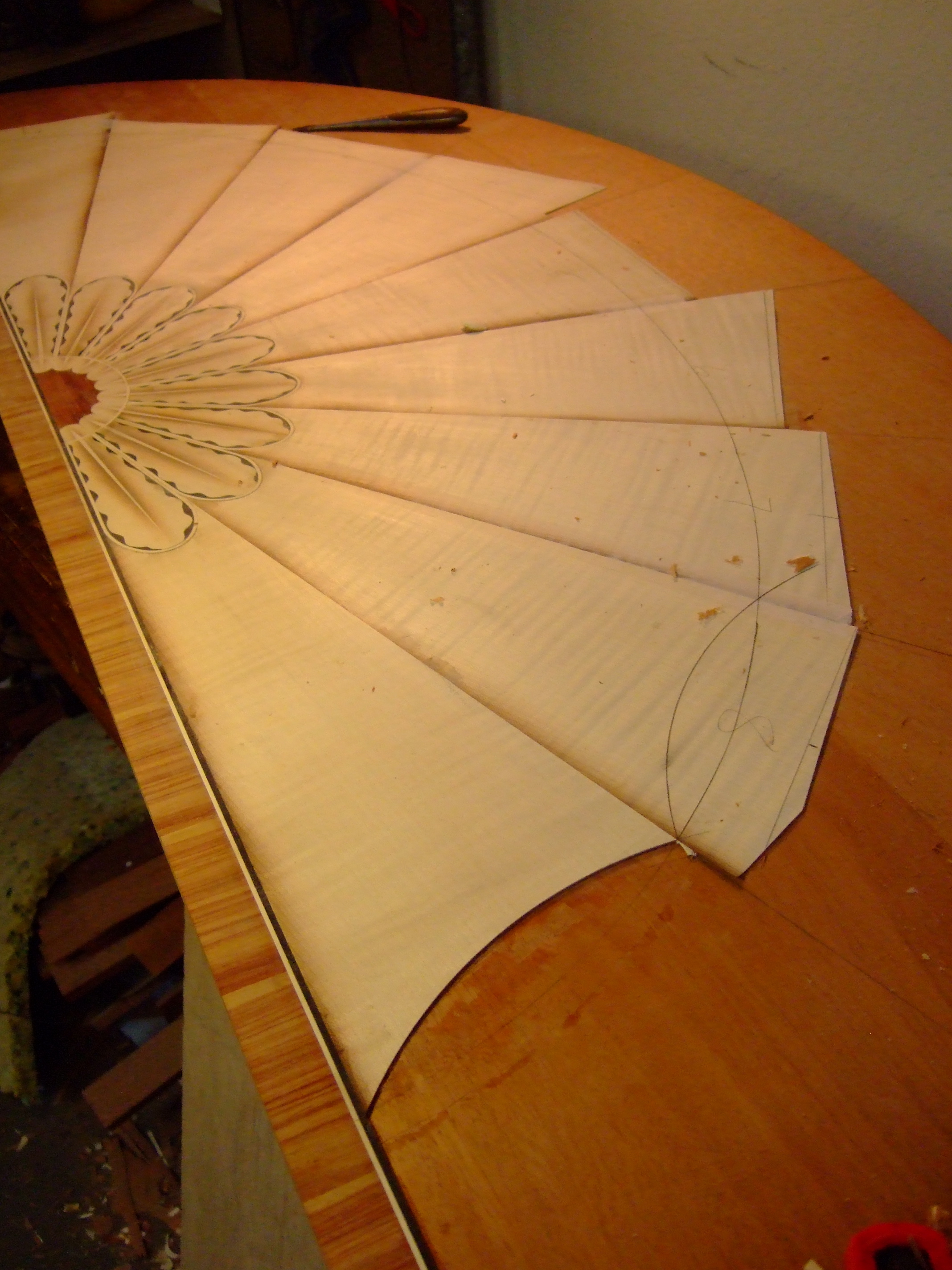 Shaping the sand shaded sycamore fan after veneering the pieces to the mahogany core.