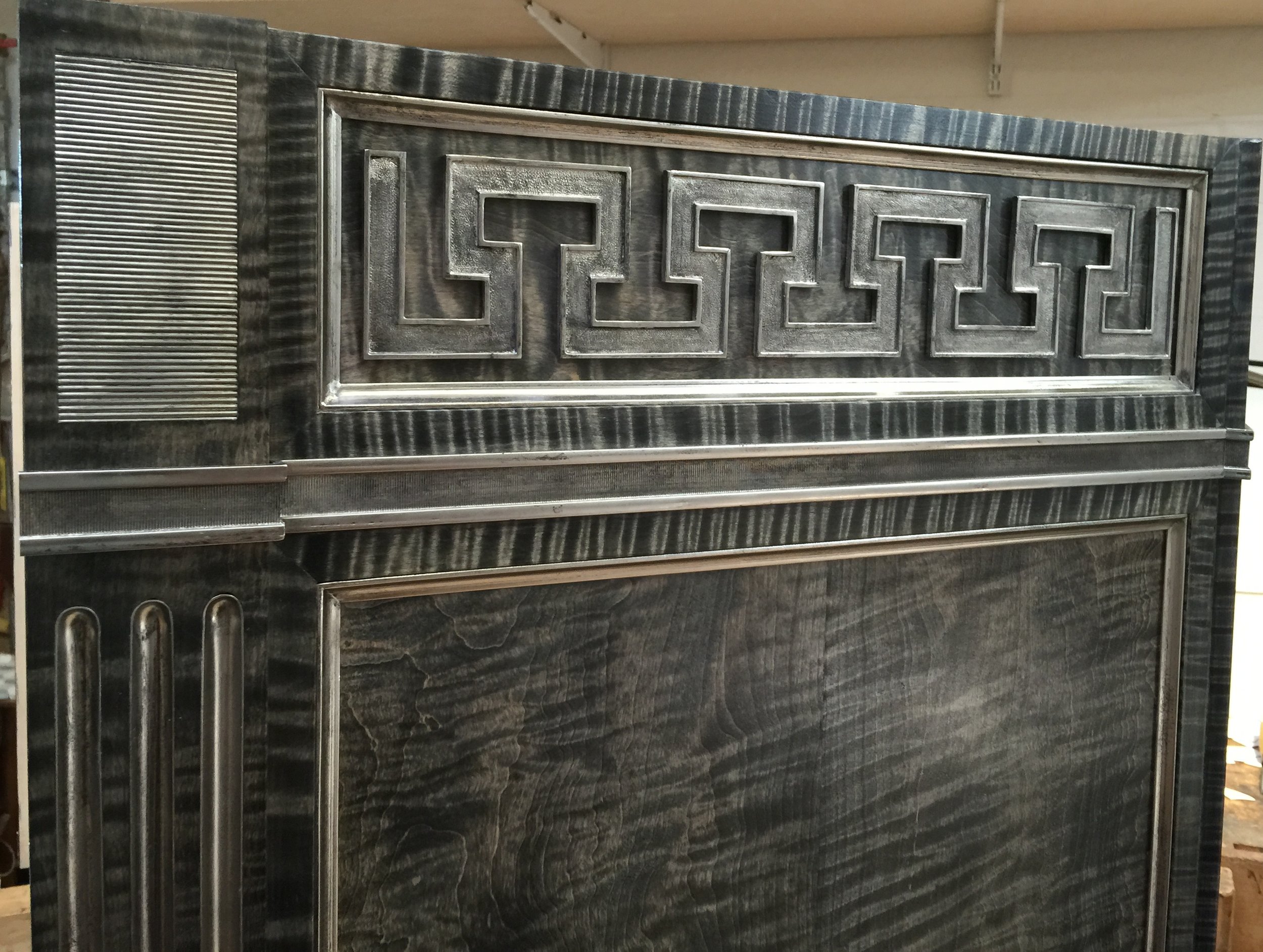 Detail of the upper side. Note that the grain behind the Greek key runs horizontally.