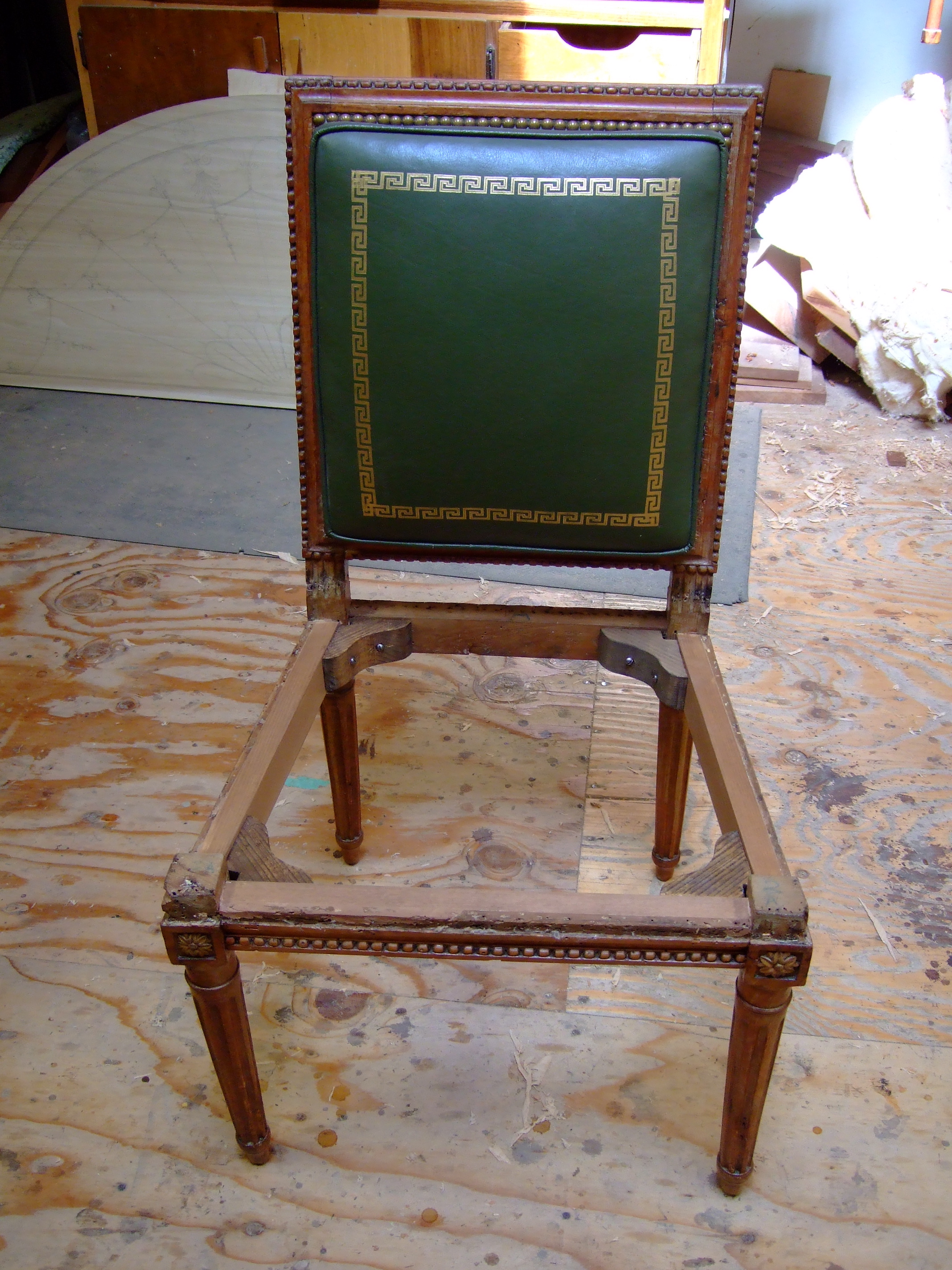 The front and two side rails replaced and veneered with the old molded and beaded exterior rails. The chair was sent to an upholsterer to reattach the original upholstery.
