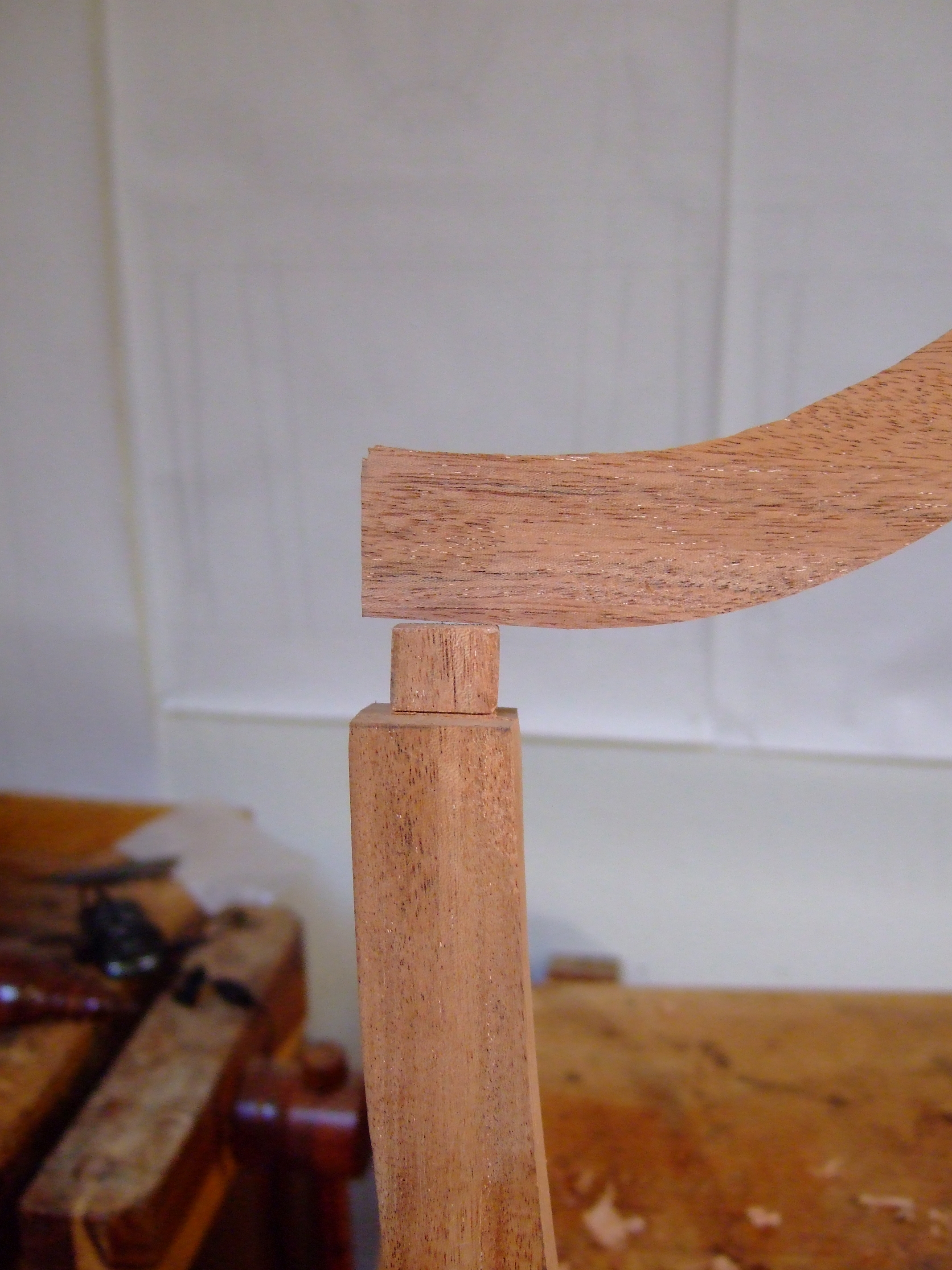 The mortise and tenon joint that connects the rear posts to the crestrail.