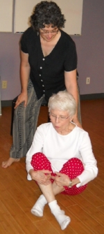 The Poise Project Team Member, AT teacher Robbin L Marcus working with a student on getting on and off the floor with grace and ease.