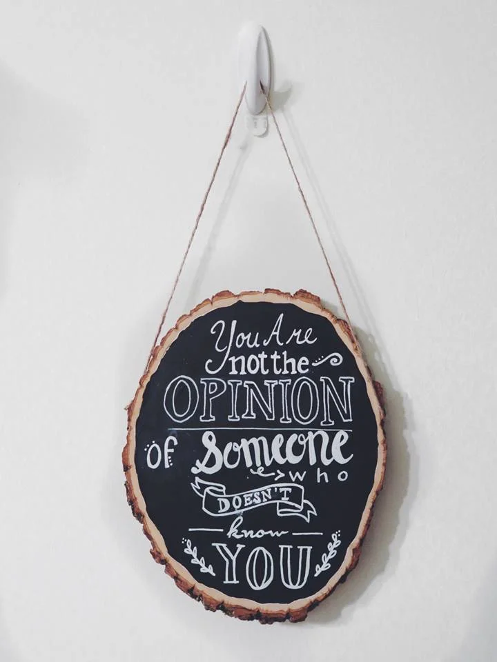 I made this using a wood slab I got from the craft store, chalk board paint, a chalk board marker, and nailing in a piece of twine on either side to hang it up.