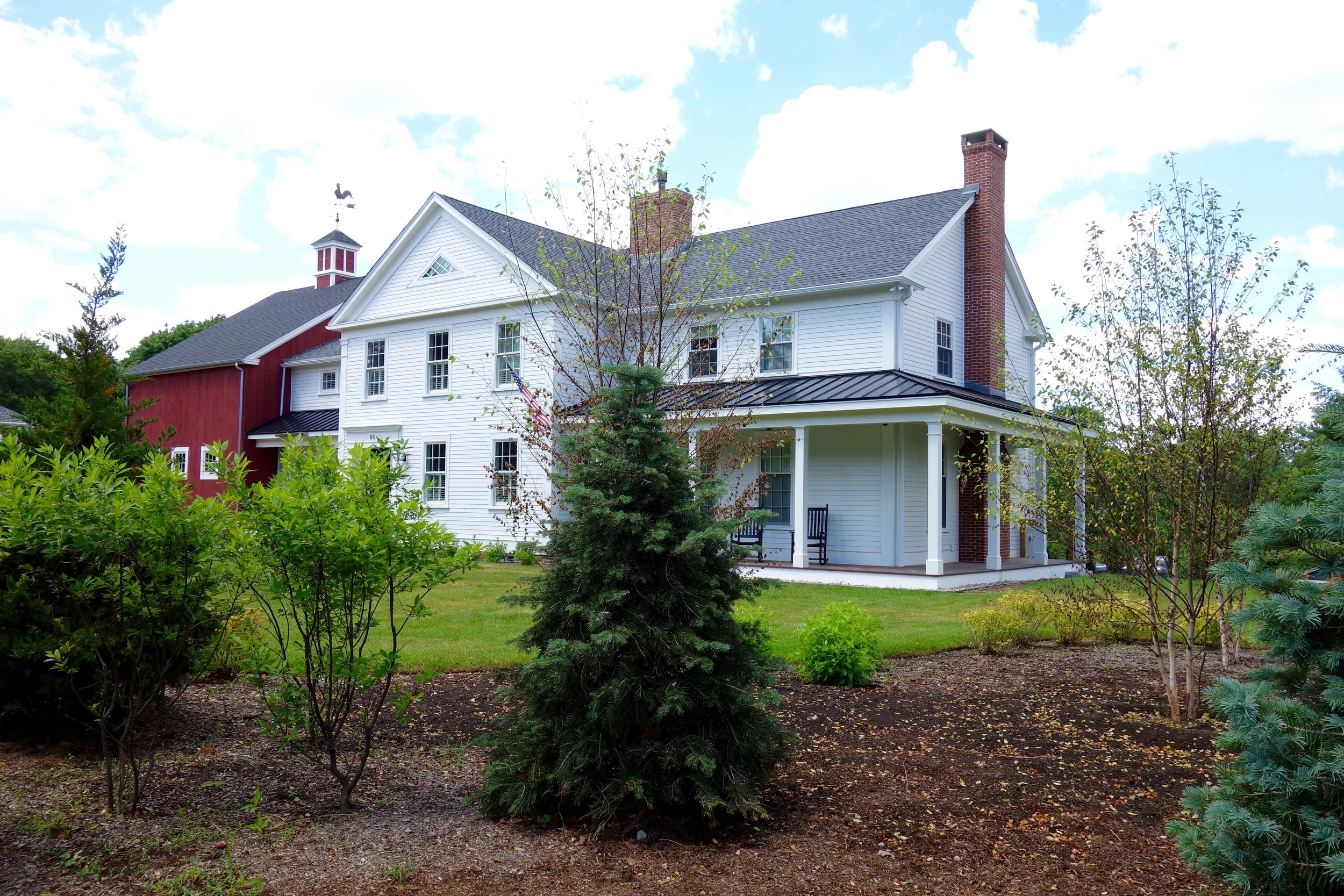 For the owners of this Greek Revival-style home adjacent to a busy suburban road, Thomas Wheaton designed a broad, layered border of plantings which will, when mature, completely screen the house from view in all seasons, providing privacy, security and noise filtering while enhancing views and supporting a thriving wildlife community.