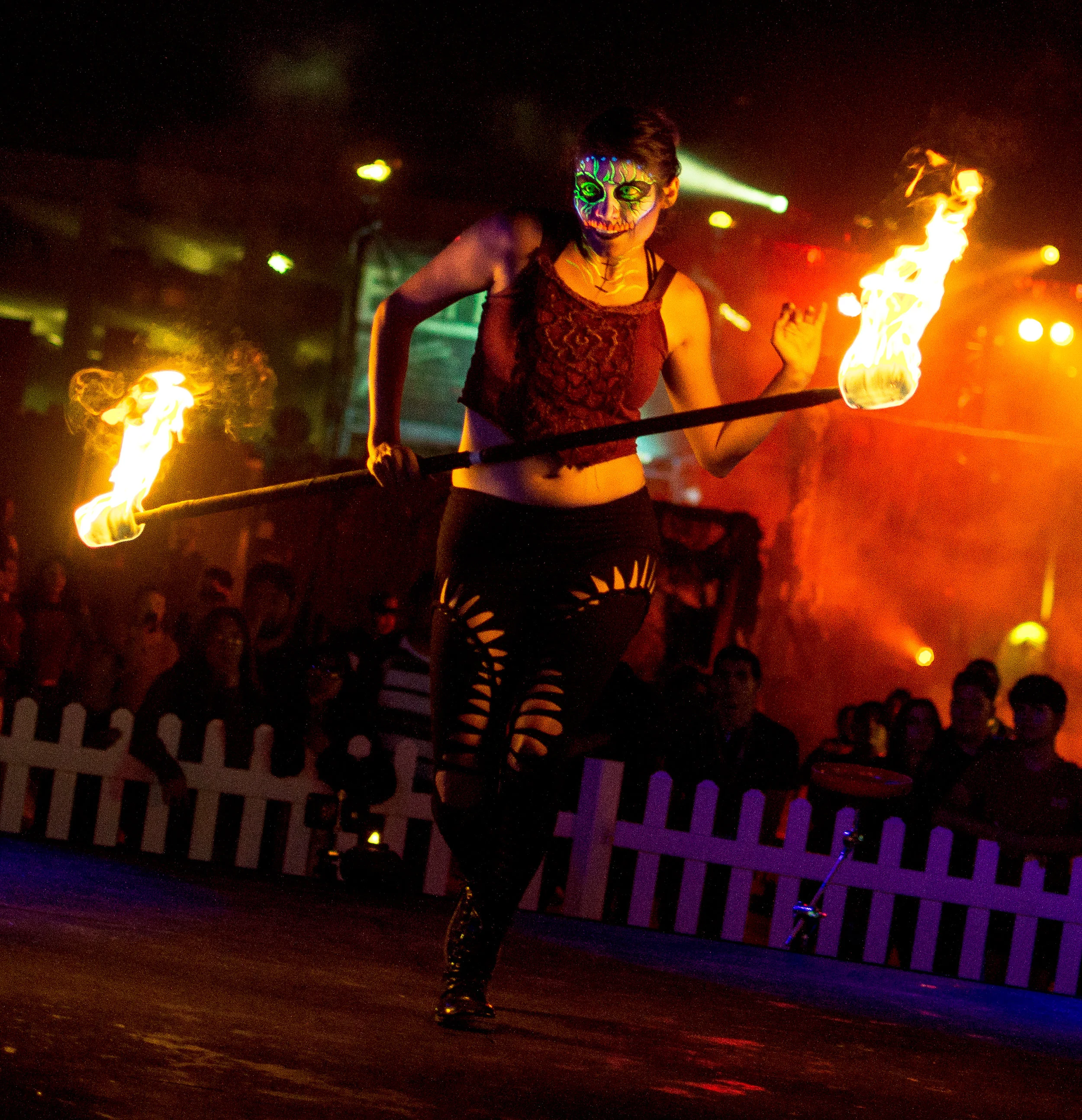 Itzel Garcia 1) When did you first begin playing with fire and what was it that made you want to start? I started in 2012, but started spinning in 2001 with some high school colorguard. I wanted to spin fire since I saw it in the circus when I was a kid. 2) When and where was your first official fire performance? It was with the 2012 Burning Sensation Fire Conclave for Burning Man. Basically, groups audition to perform at Burning Man, and are chosen by the Fire Council based on specific criteria. I helped choreograph that performance as well! 3) What was the first apparatus you learned? Staff! I have a love of all things stick (lol), so most of my props are staff based. 4) How many different apparatuses have you performed with? Staff, Dragon Staff, Double Staff, Levitation Wand, Rope Dart, and quite a few others that I'm not proficient in, but can fake well enough. 5) What precautions go into each performance? Making sure our entire costumes are fire safe and fire treated, making sure our props are well maintained, and check that we have enough fuel to get through each performance. 6) What do you do to prepare for a performance? It depends on the type of performance! For choreographed performances like Dark Harbor, I like to do a mental run through of my piece to make sure I have the important bits down. For ambient spinning, I just do a little bit of pre-spinning to warm up. 7) How many years have you been with Dark Harbor? I started performing with Dark Harbor in 2014. 8) How often do you practice with your Dark Harbor crew? I'm the furthest from the group (I'm in South OC) so I generally don't see the crew very often. Before Dark Harbor, we meet enough times to get the positioning and group choreography done. 9) What does it feel like being on stage performing? And what do you think when you look out into the audience and see them responding in a positive way to your show? This one is hard to answer. It feels like a strong creative rush, mixed with adrenaline, and appreciation for the audience for appreciating our art. A positive reaction from the audience will ALWAYS feed the performer to spin with more energy, so please cheer on the performers! We love feeling that energy :) 10) Is there a permit or certification required to perform with fire? There is no permit required to pick up a prop and perform, however, there are permits required to perform with fire in almost every area, and some props can't be handled without proper certifications (things similar to fireworks, etc). However, there is a movement to push for a unified set of guidelines for fire performers that will hopefully gain more traction in coming years 11) In your opinion, what separates a skilled performer from a natural performer? A natural performer is someone who can move with a prop or with music well without putting too much work into it. A skilled performer is someone who practices and works hard to increase their connection with the audience. Someone who can make someone watching a PART of their performance. To me, that's the real skill. Making the audience forget where they are for a moment, being able to mesmerize. 12) How much further would you like to take your performance? Is there anything you haven't tried/mastered yet that you'd like to perfect? There is always SO much to try and master! I'm currently working hard to build up the skills on the props I already have, and have acquired on additional circus apparatus that I'll hopefully be able to perform with in the coming year. It takes time to practice :) 13) Any advice for beginning artists/performers? PRACTICE, PRACTICE, PRACTICE! No one ever gets better by thinking about it. Only in doing will you get to where you want to go.