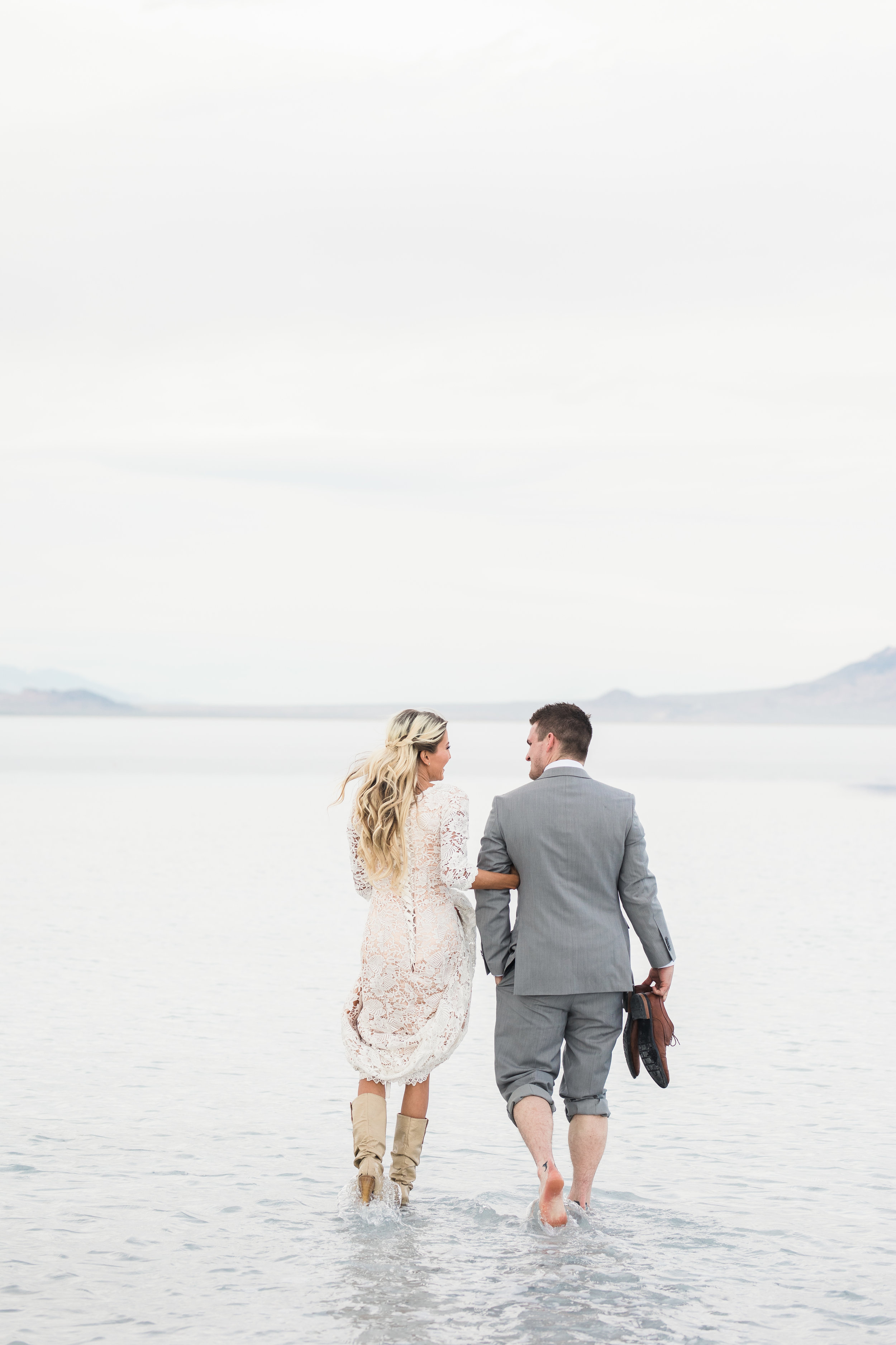 Bride and groom walking through water Bonneville Salt Flats Utah bridals