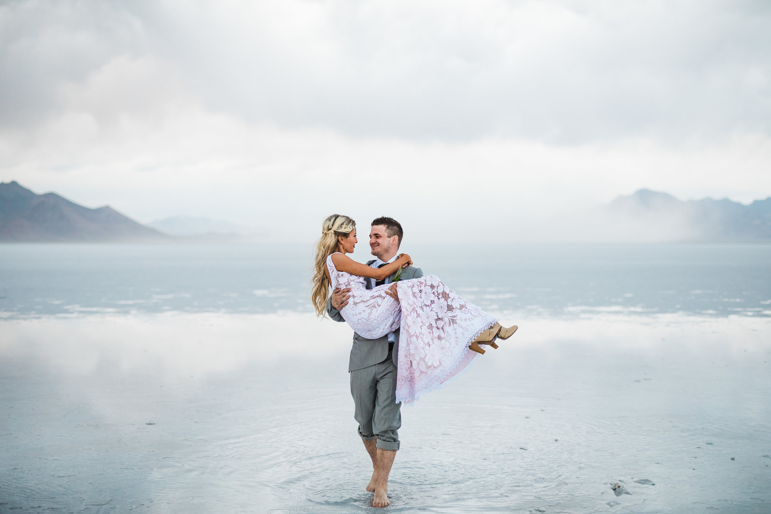 Bride and groom walking across the water unique wedding pictures Bonneville Salt Flats