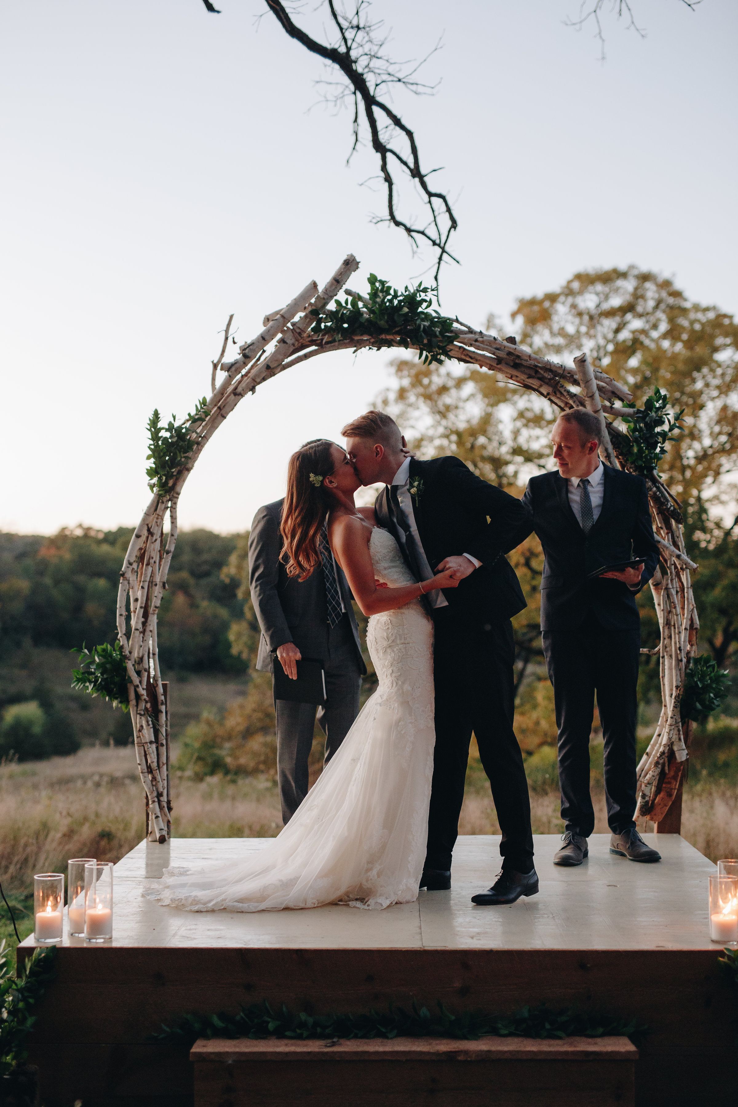 Bride and groom first kiss at wedding ceremony adventure wedding photographers Minnesota