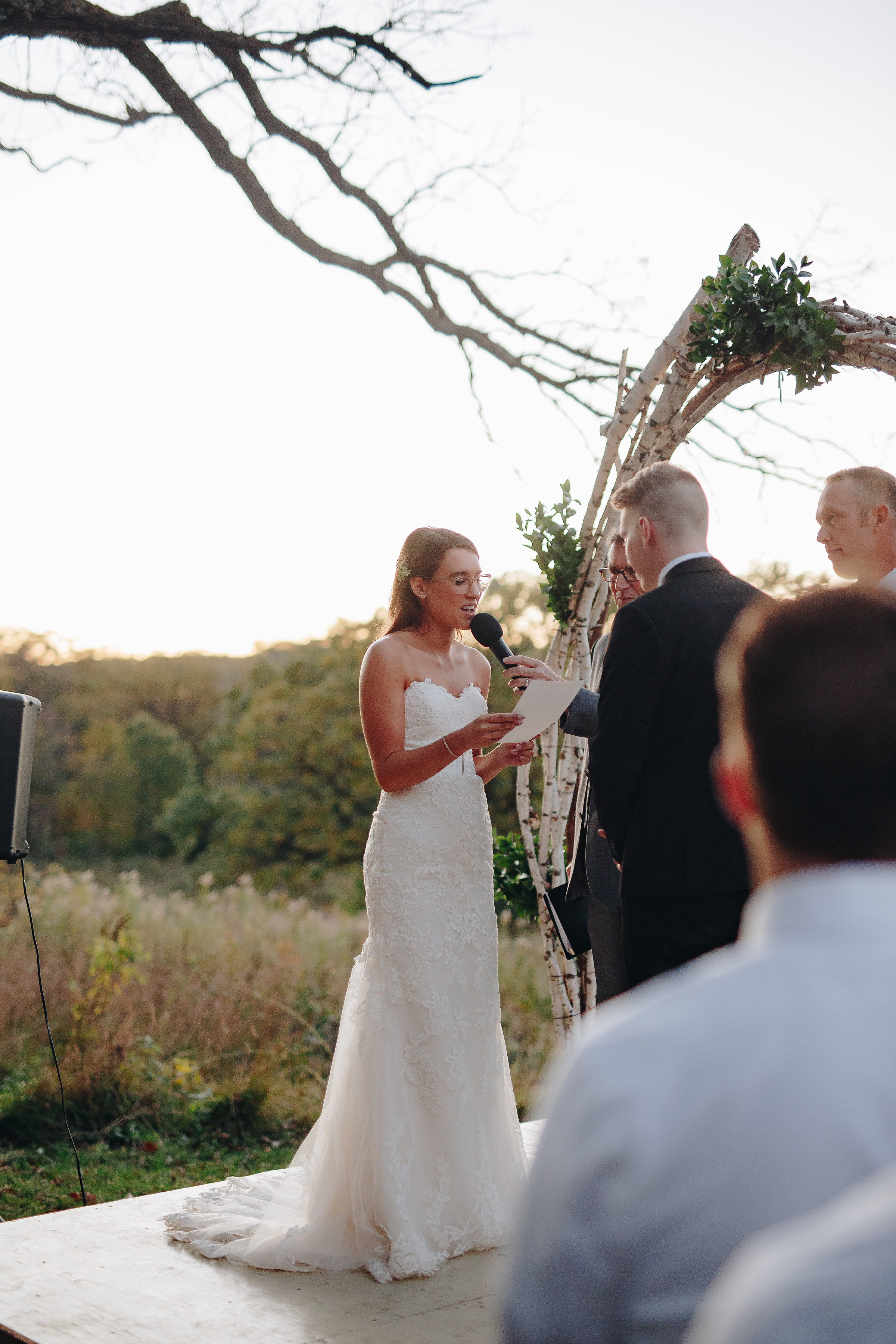 Bride reads her vows to her groom at wedding post sunset ceremony